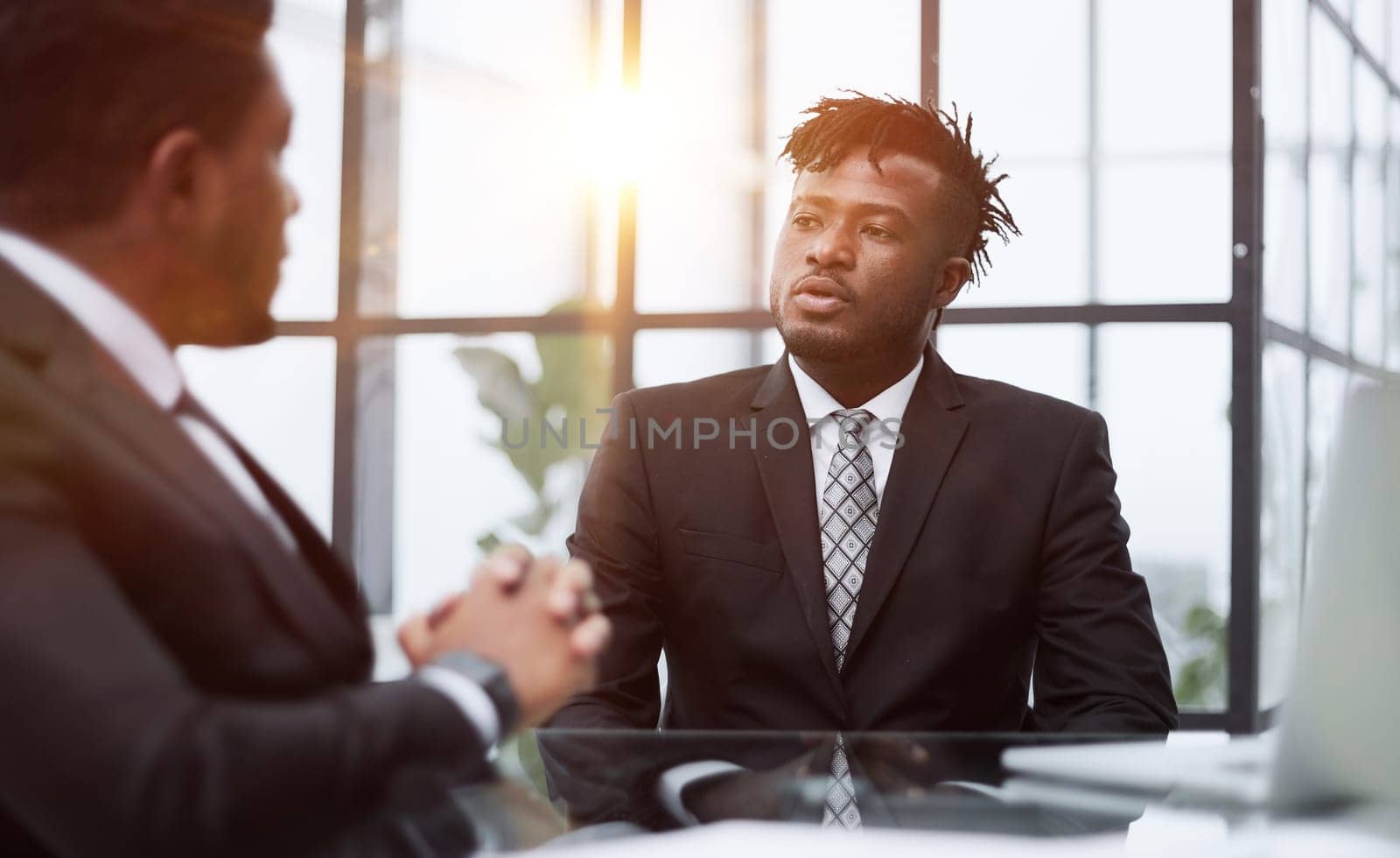 mentor coach worker talking to male coworker teaching intern having business conversation with workmate