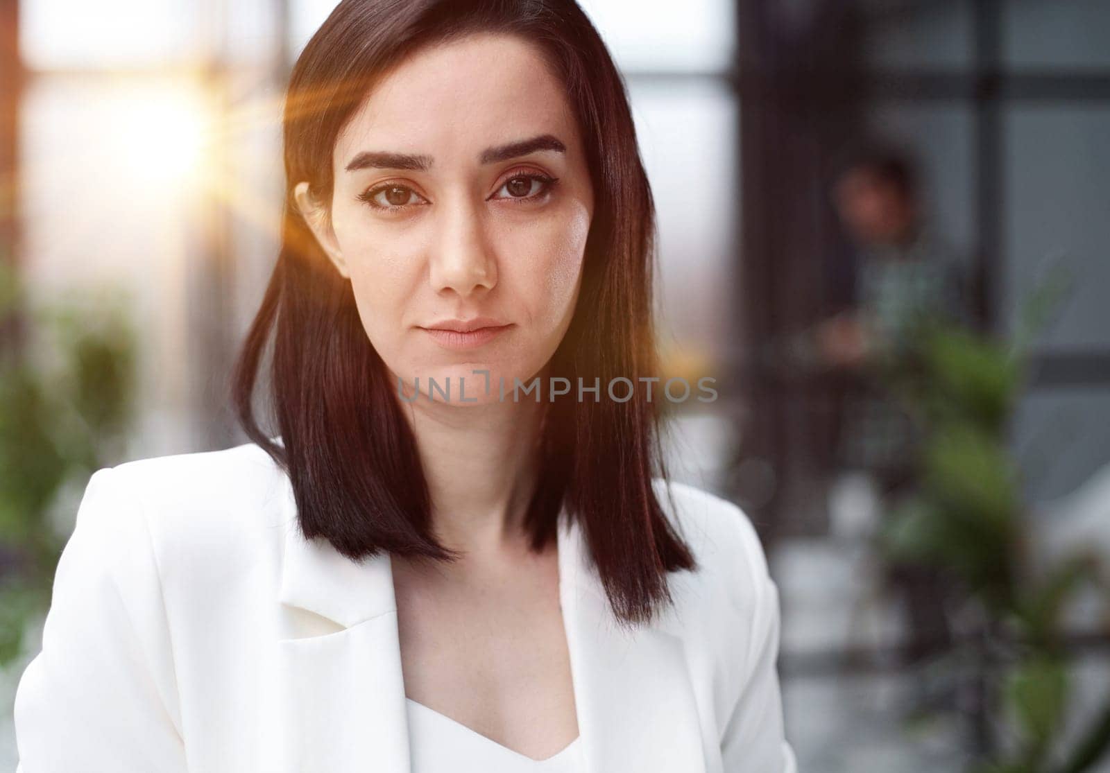 Beautiful young lady in white jacket smiling at camera by Prosto