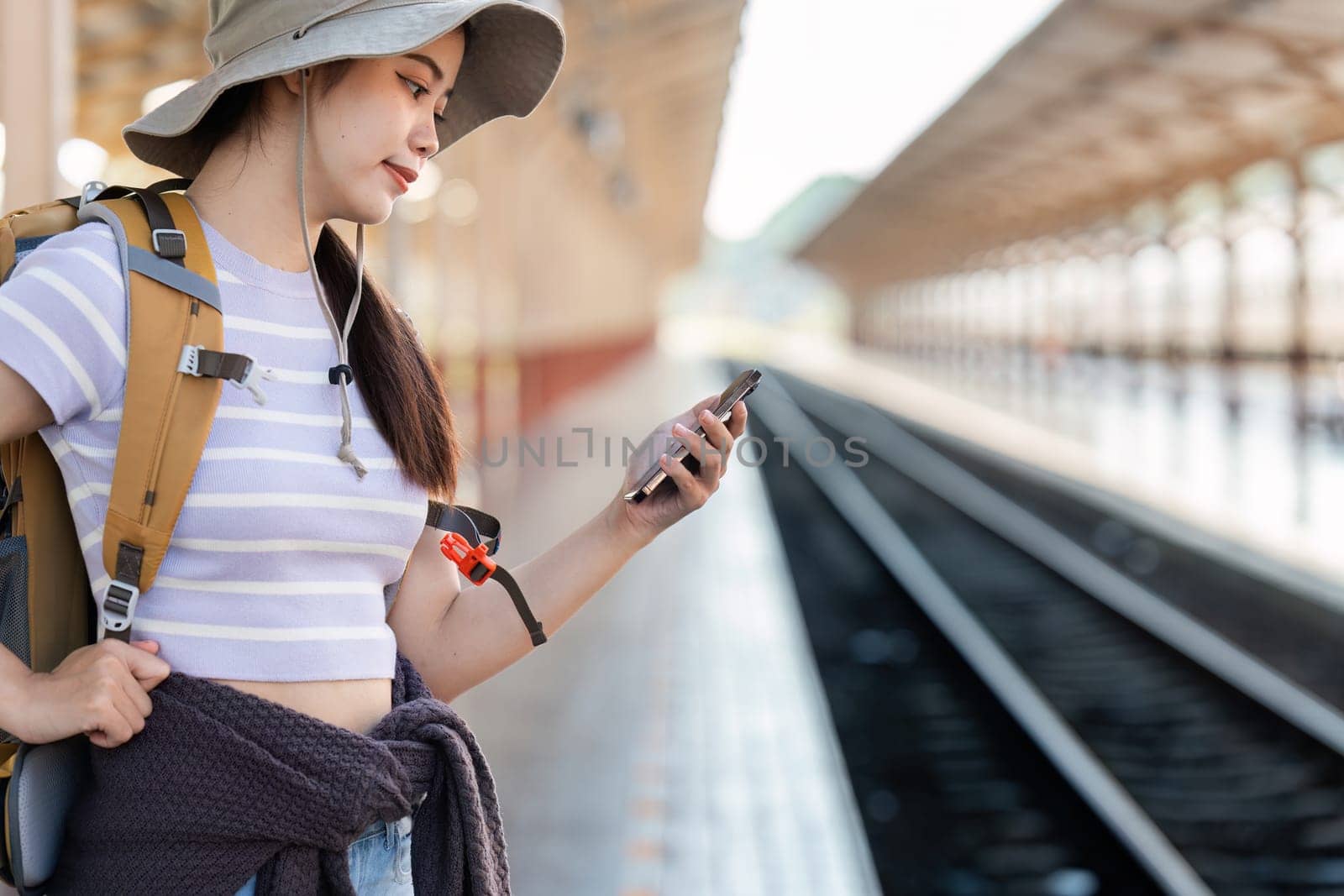 Woman using mobile phone while travel by train. travel concept.