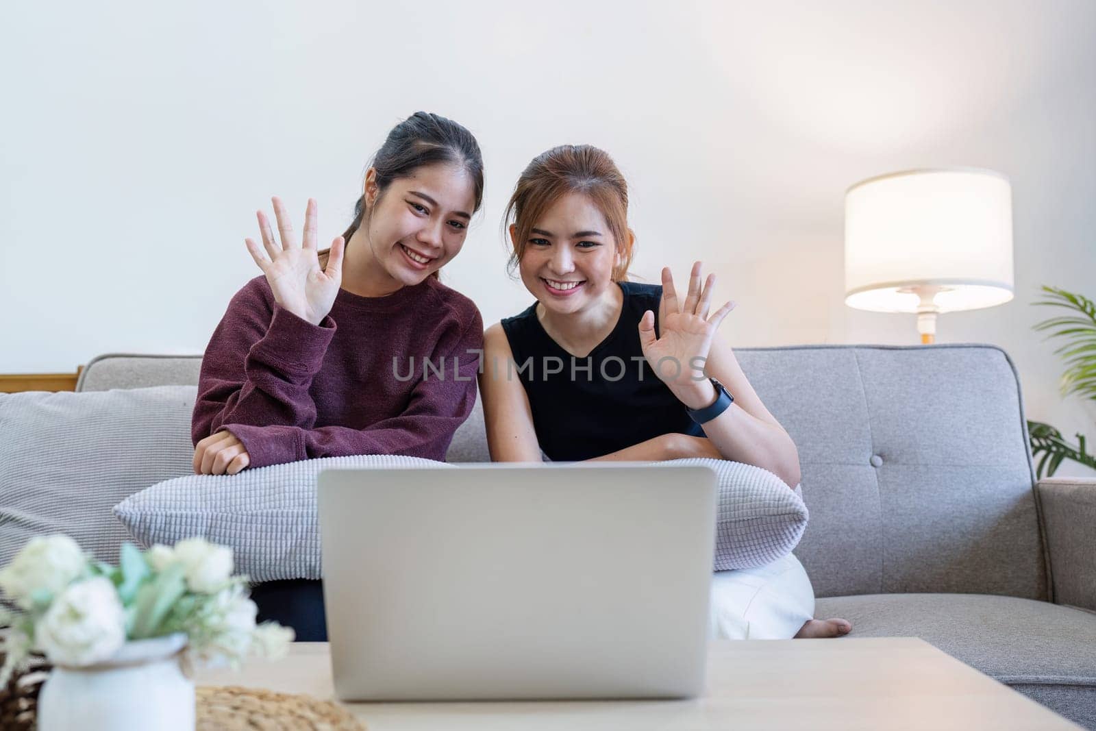 two happy woman using laptop computer working online in office.