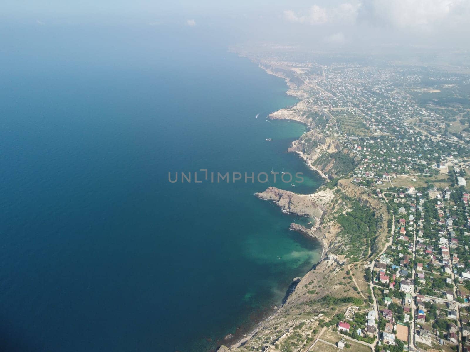 Aerial panoramic view of beautiful sunset above sea. Beautiful seascape. Sun glare, small waves on the water surface. Evening. Horizon. Nobody. No people. Copy space. Never-ending beauty of nature