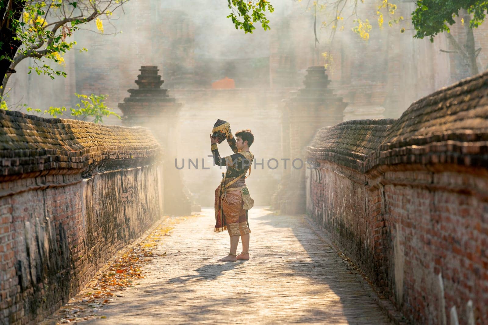 Khon or traditional Thai classic masked from the Ramakien characters as black monkey dance in front of ancient building and stay on the way of old wall.