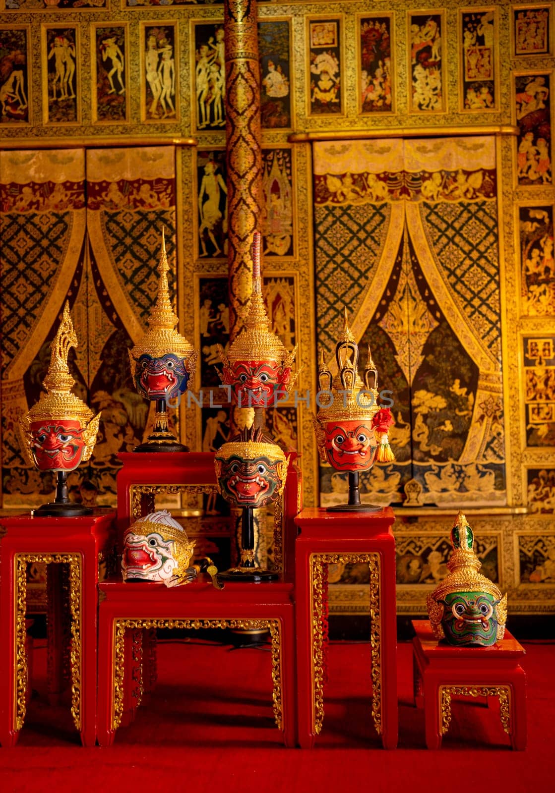 Vertical of beautiful ancient traditional Thai pattern Pantomime or Khon masks are set up on wooden shelves