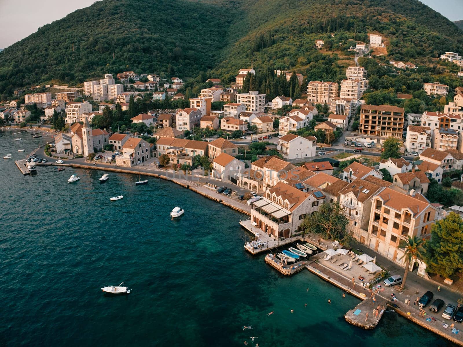 Promenade with old houses and moored boats. Tivat, Montenegro. Drone. High quality photo