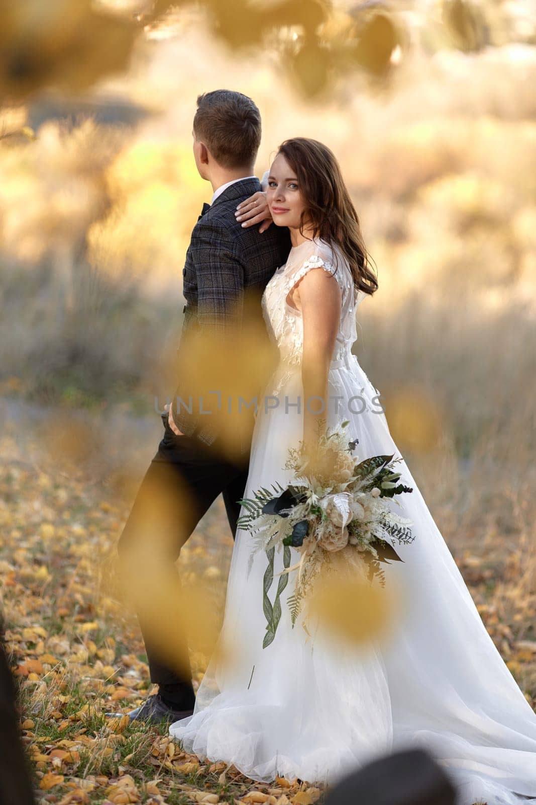 Groom and bride together standing outdoor on natural background