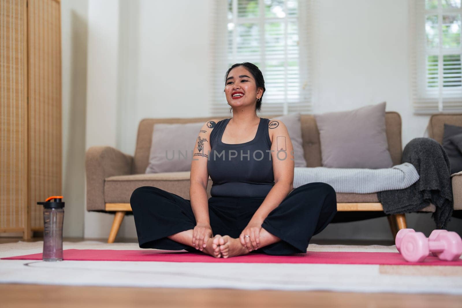 Asian overweight woman doing stretching exercise at home on fitness, Stretching training workout on yoga mat at home for good health and body shape.