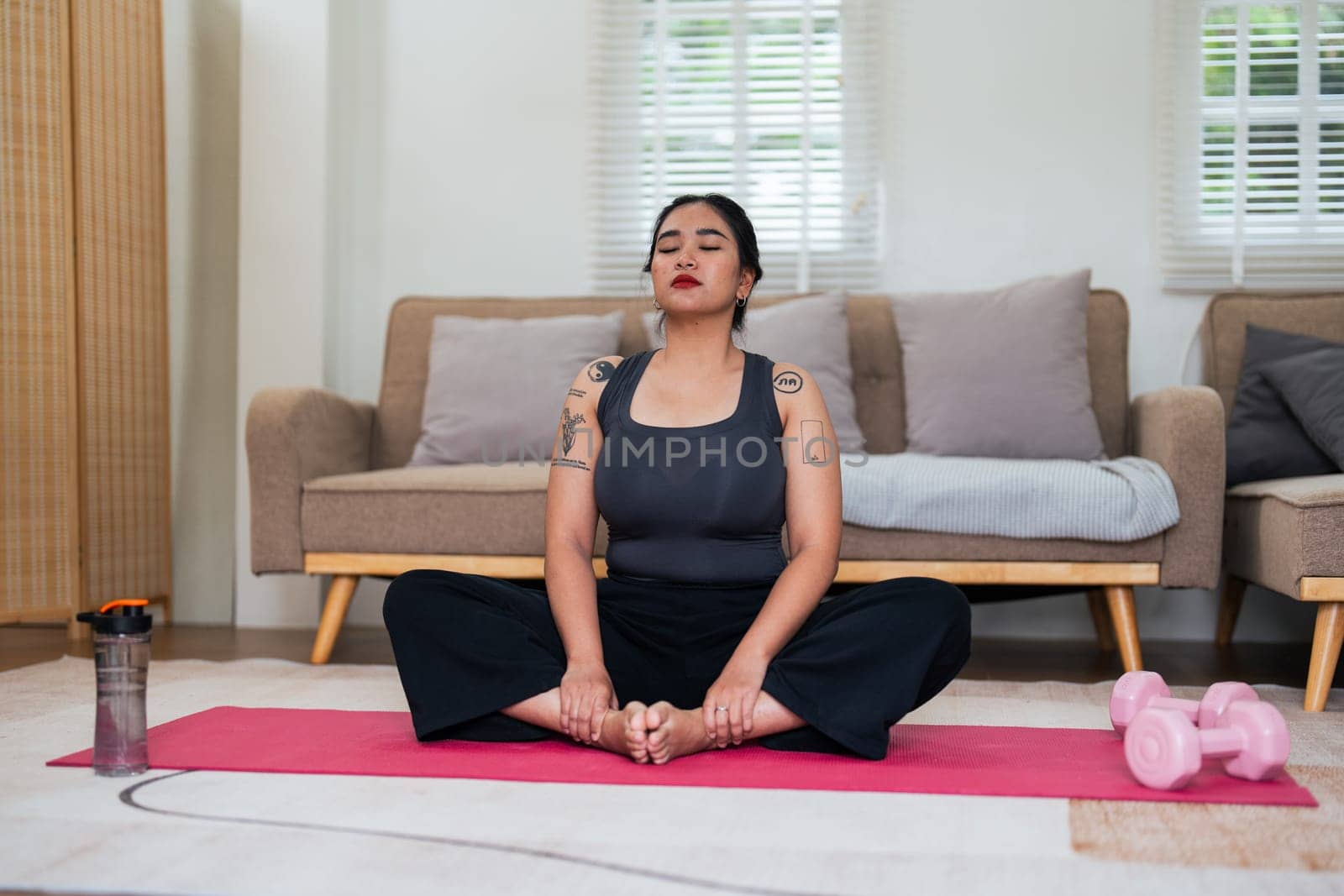 Asian overweight woman doing stretching exercise at home on fitness, Stretching training workout on yoga mat at home for good health and body shape by nateemee