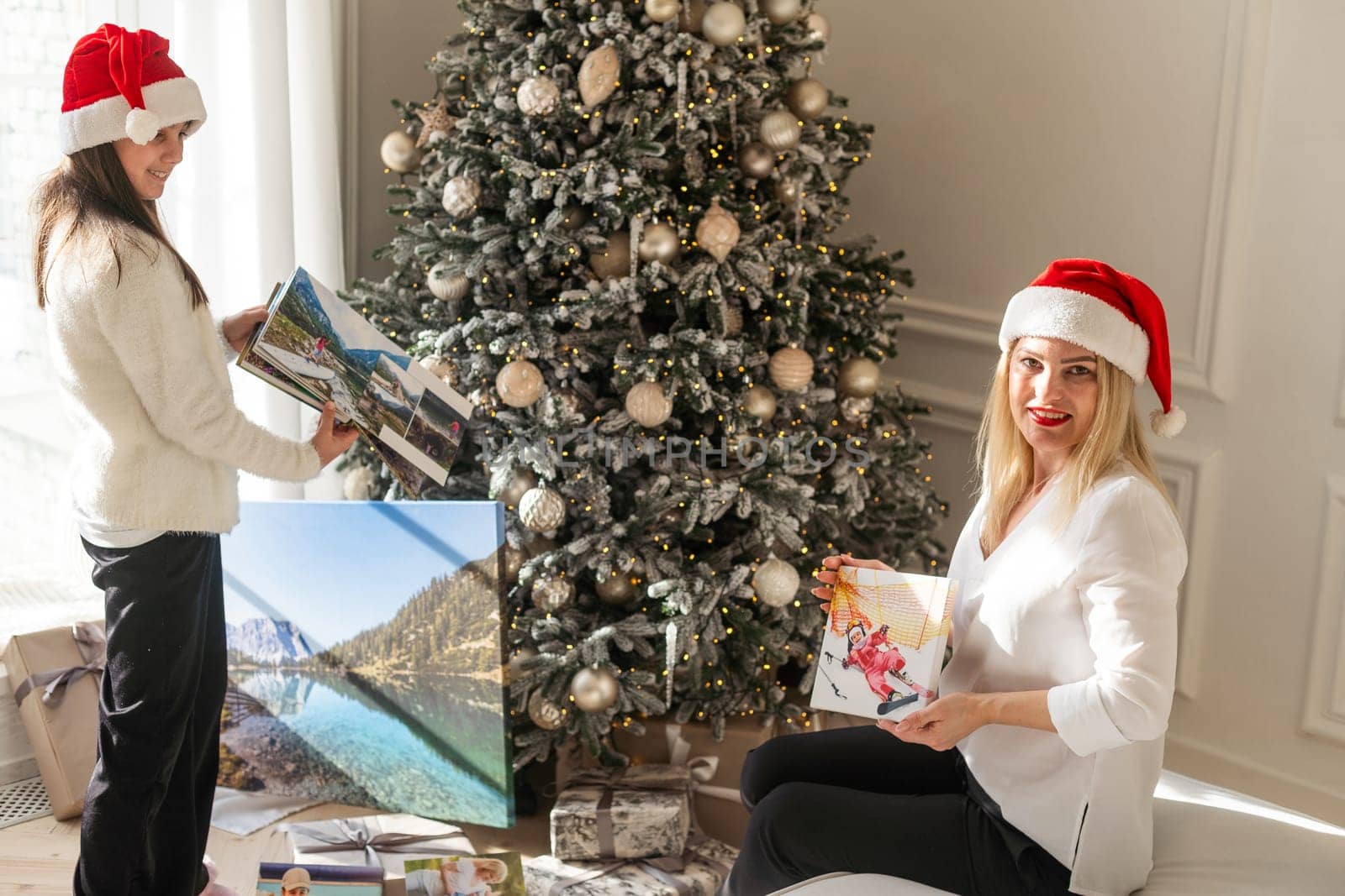 Mother and her daughters opening the little girl's birthday present. High quality photo