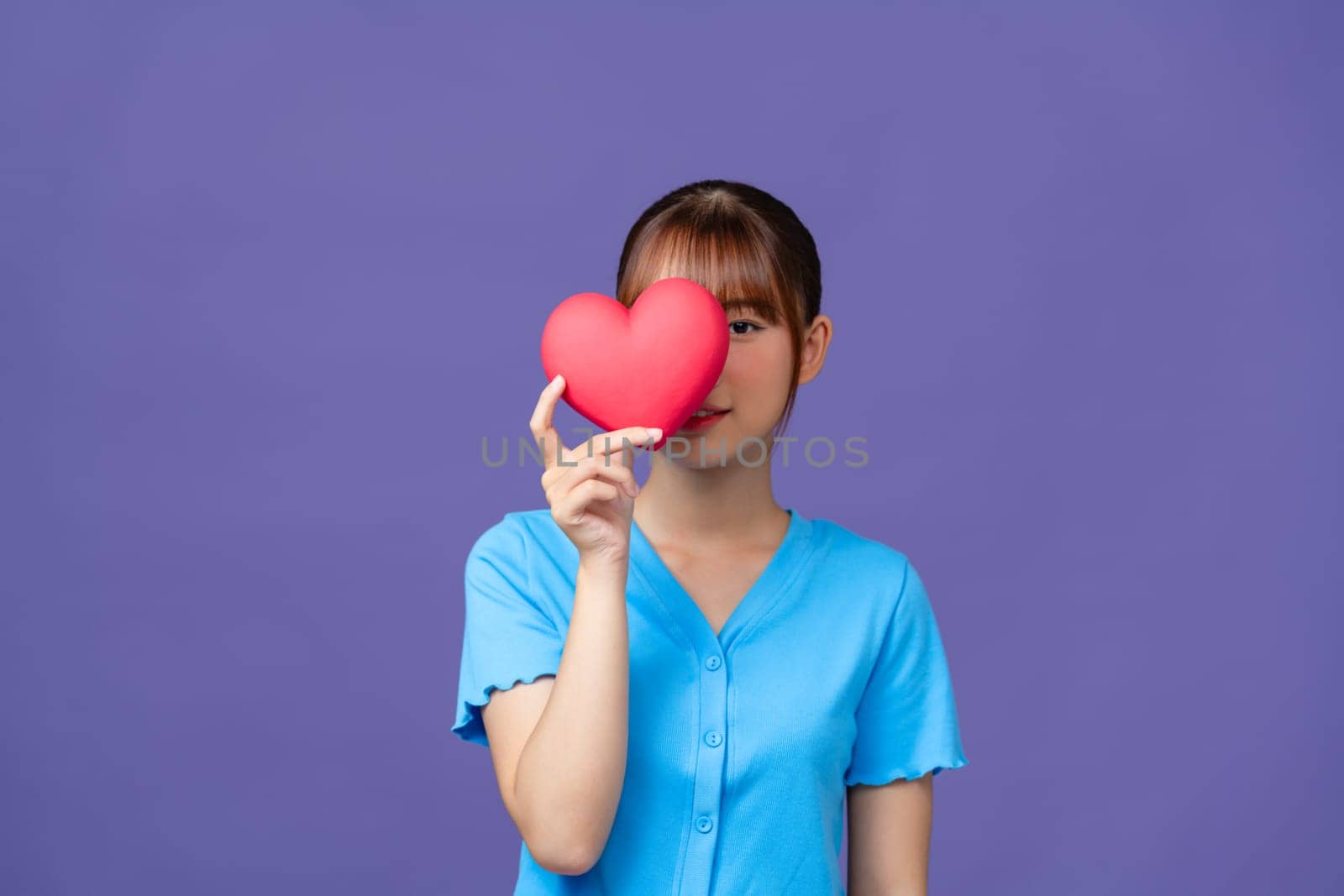 Heart. Love symbol. Portrait of beautiful happy woman hold Valentine day symbol. by makidotvn