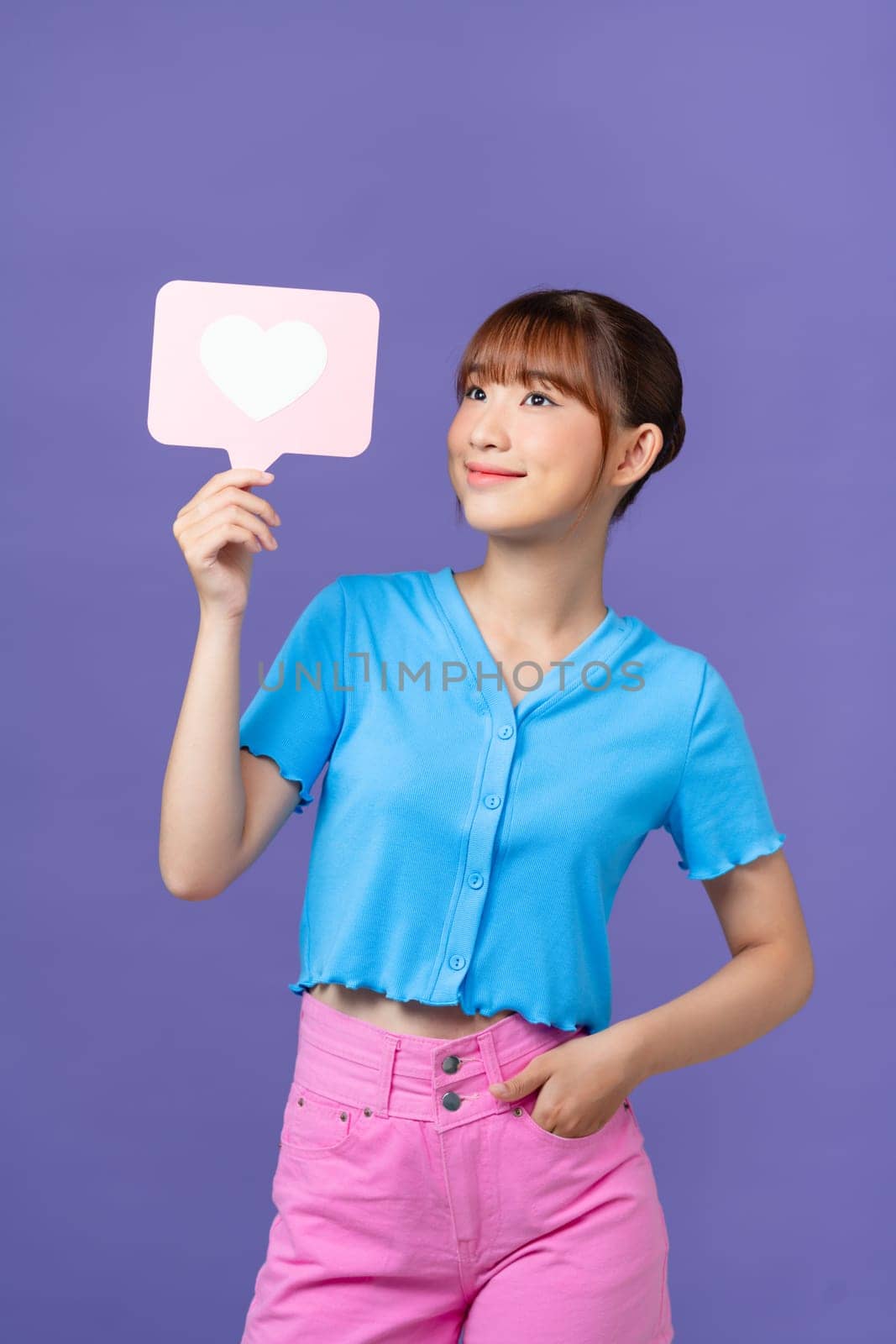 Photo of positive sweet lady smiling rising heart like card isolated on purple background by makidotvn