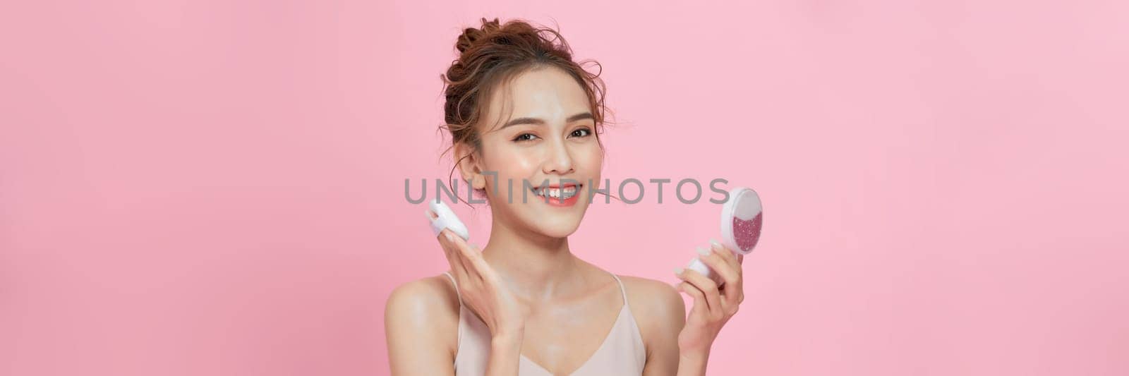 Gorgeous woman applying her cheek with dry powder by makidotvn