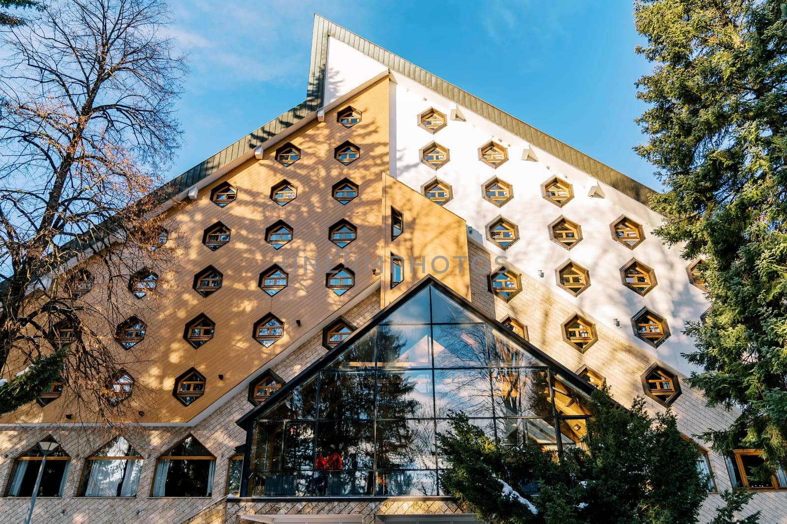 Triangular Bianca Resort and Spa hotel with honeycomb windows in the forest. Kolasin, Montenegro. High quality photo