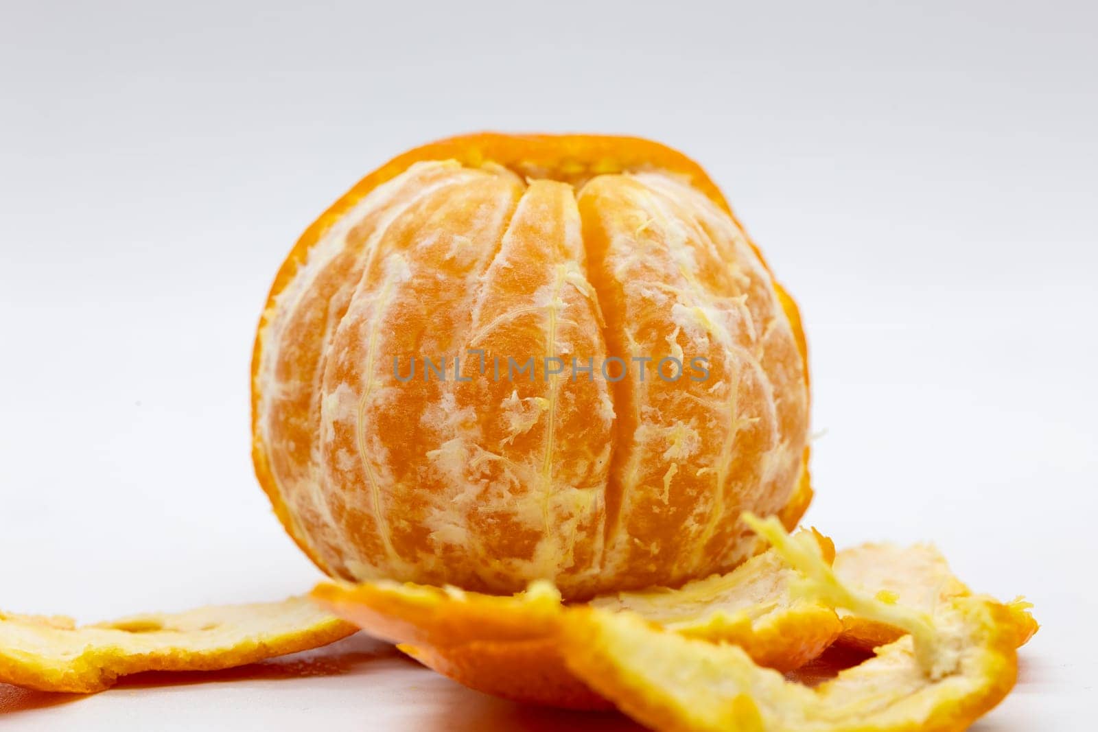 A closeup of a tangerine on a white background