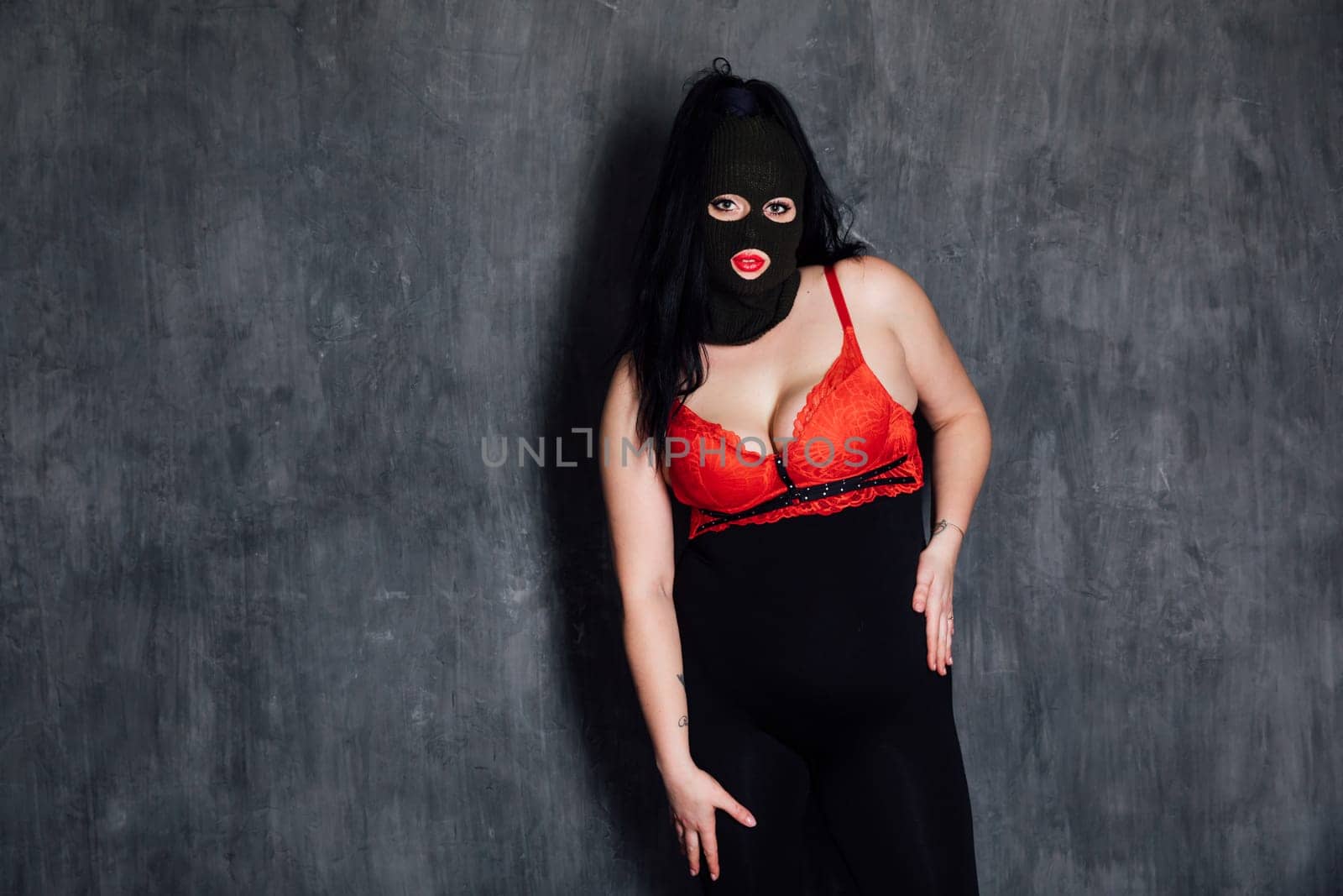 A masked woman in a room is a bandit