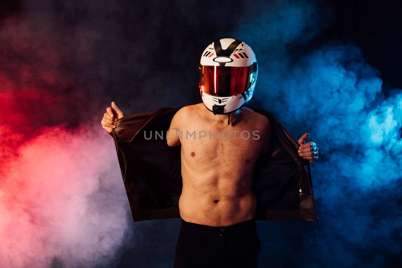 Male motorcyclist wearing helmet in smoke by Simakov