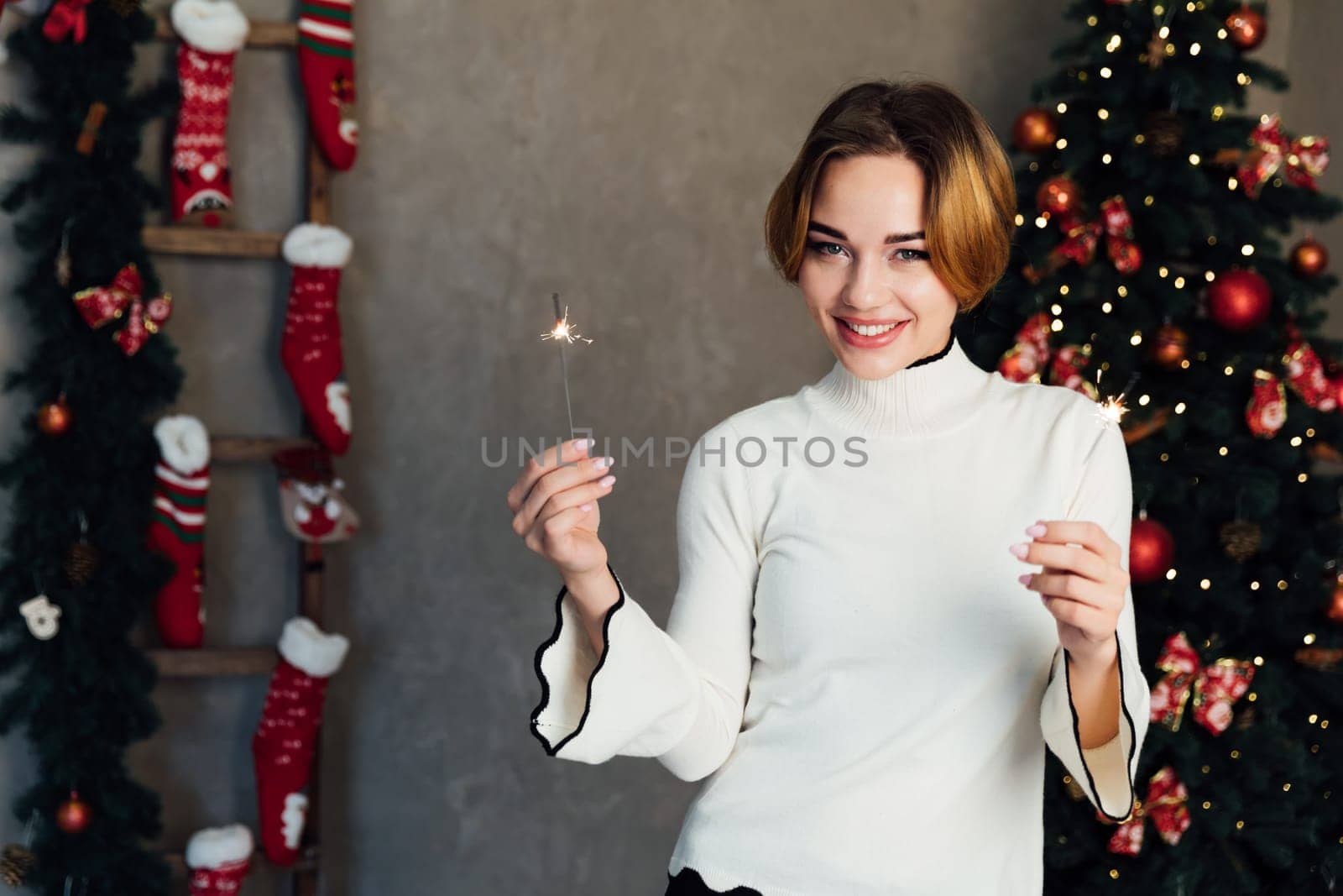 Woman with sparkler celebrates New Year's Eve Christmas by Simakov