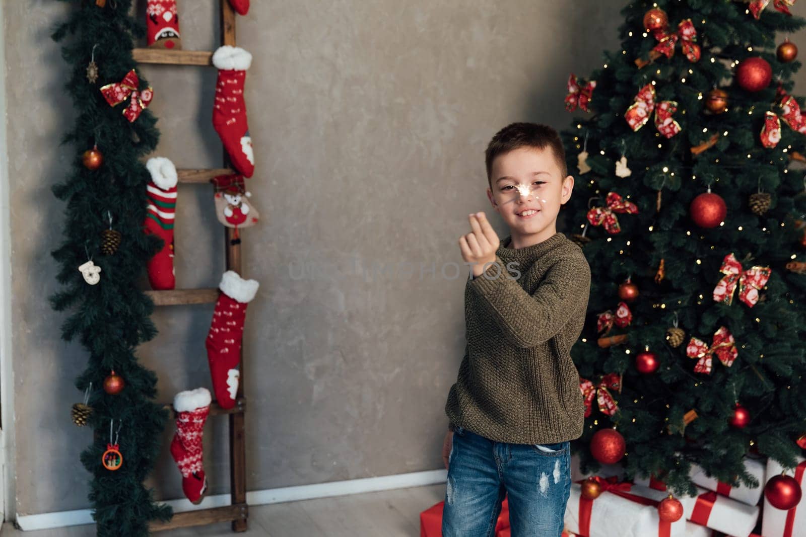 Boy with sparkler celebrates New Year's Eve Christmas by Simakov