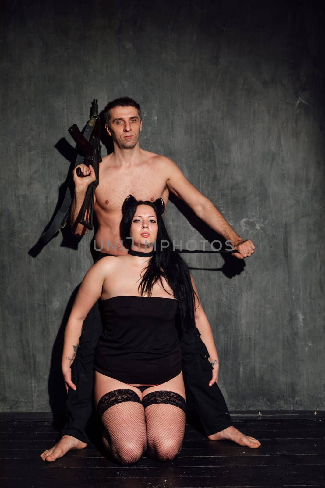 An attractive man and woman couple with guns by Simakov