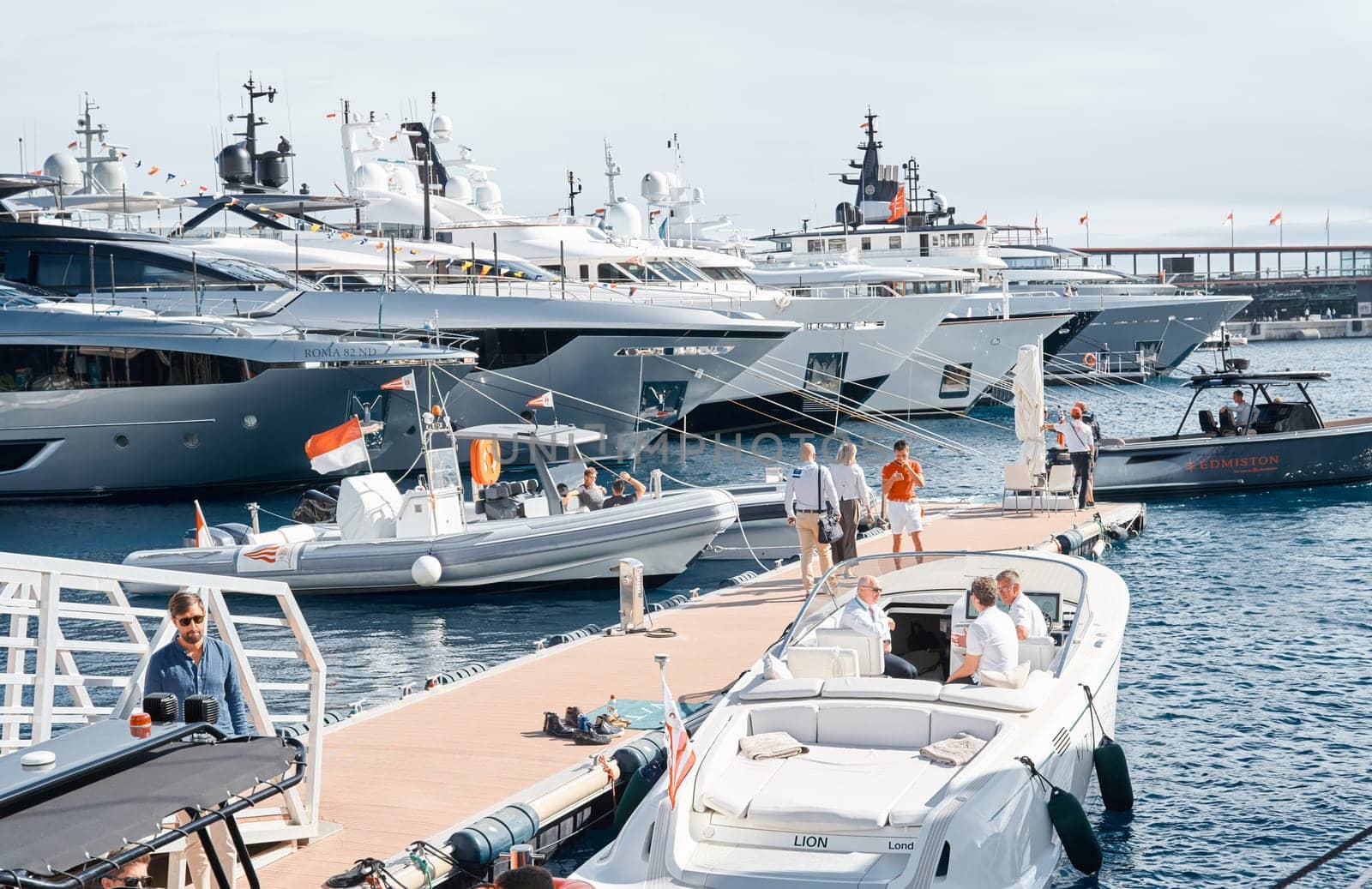 Monaco, Monte Carlo, 29 September 2022 - a boat with guests of yacht brokers departs from the shore in the largest fair exhibition in the world yacht show MYS, port Hercules, rich clients, sunny by vladimirdrozdin