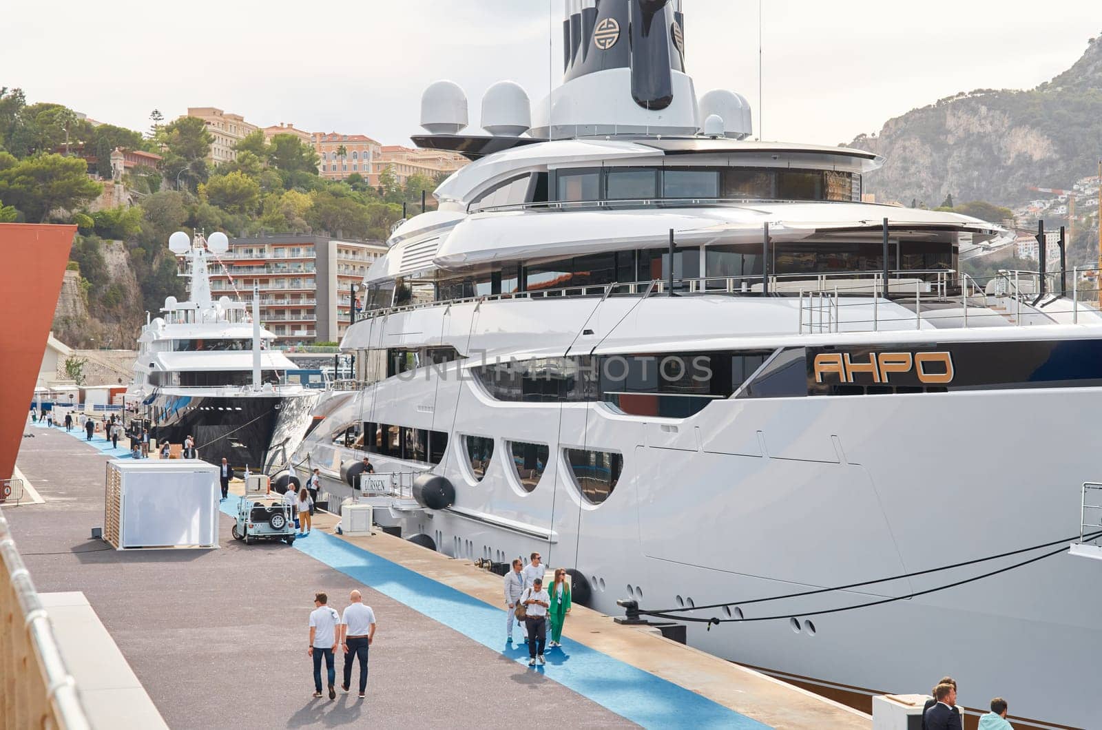 Monaco, Monte Carlo, 29 September 2022 - Invited wealthy clients inspect mega yachts at the largest fair exhibition in the world yacht show MYS, port Hercules, yacht brokers, sunny weather. High quality photo