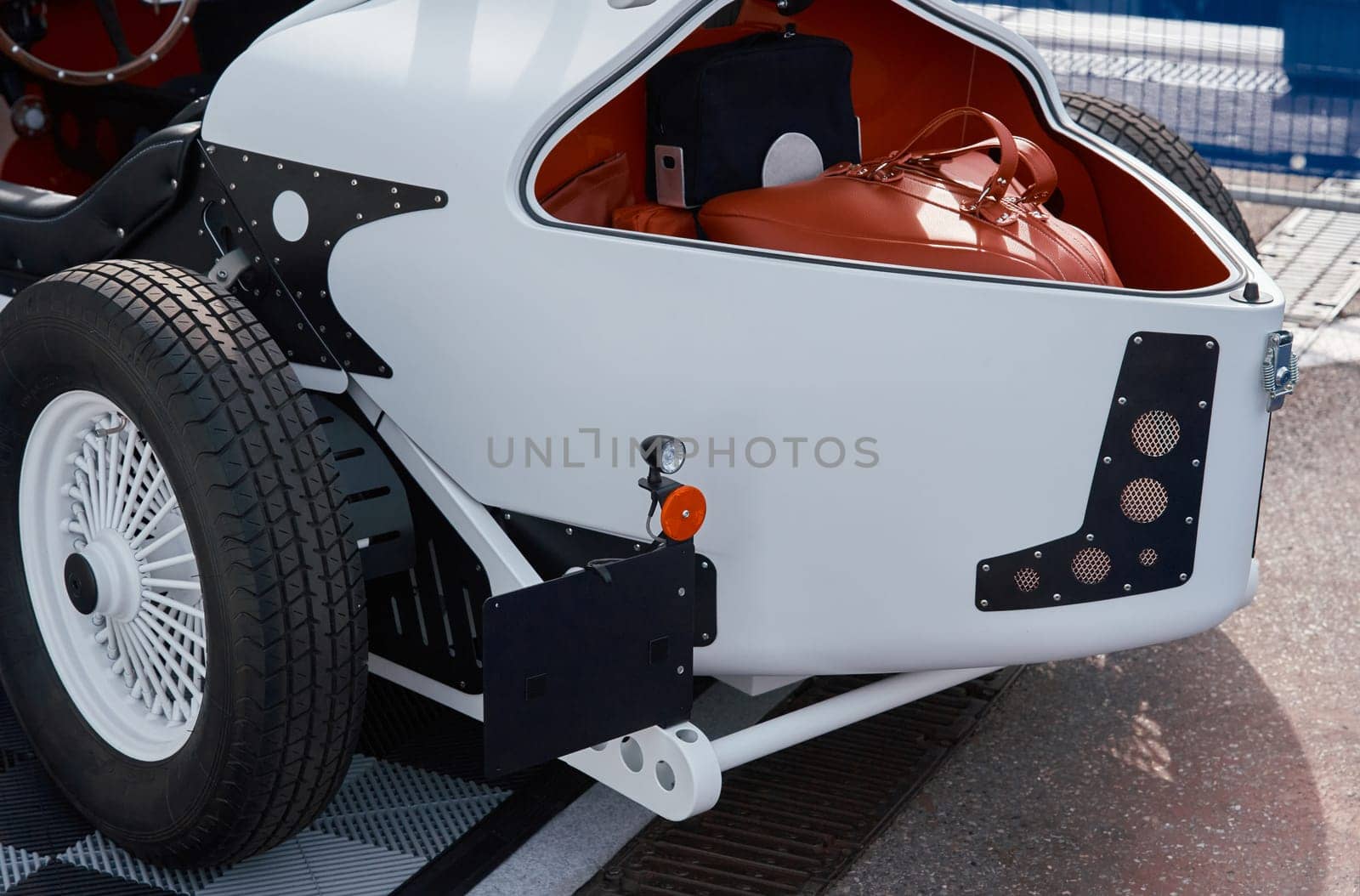 vintage open-top car at the yacht show in Monaco on a sunny day, leather seats, spoked wheels, close-up by vladimirdrozdin