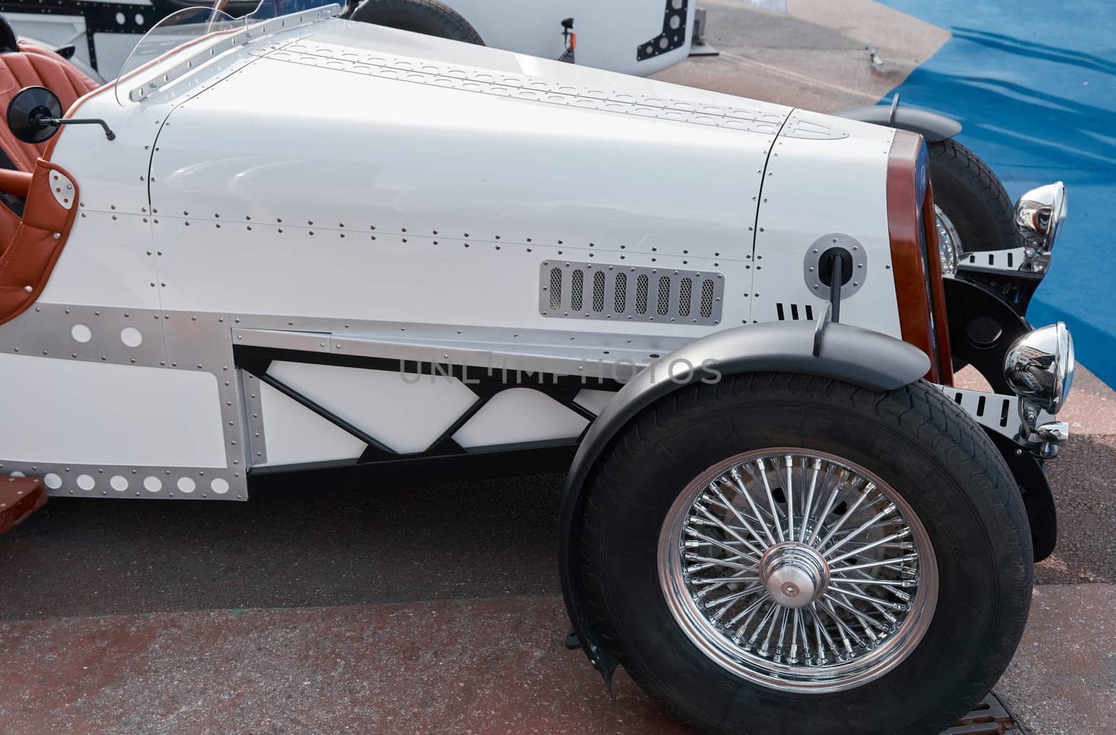 vintage open-top car at the yacht show in Monaco on a sunny day, leather seats, spoked wheels, close-up. High quality photo