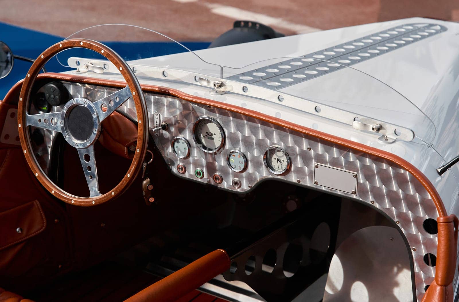 vintage open-top car at the yacht show in Monaco on a sunny day, leather seats, spoked wheels, close-up by vladimirdrozdin