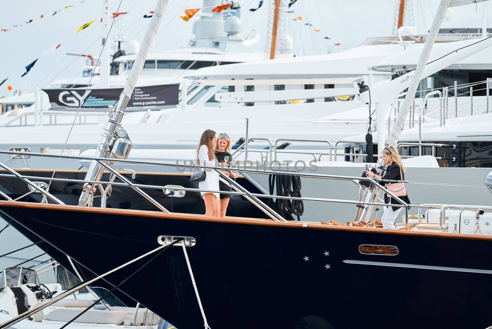 Monaco, Monte Carlo, 29 September 2022 - Invited wealthy clients inspect mega yachts at the largest fair exhibition in the world yacht show MYS, port Hercules, yacht brokers, sunny weather by vladimirdrozdin