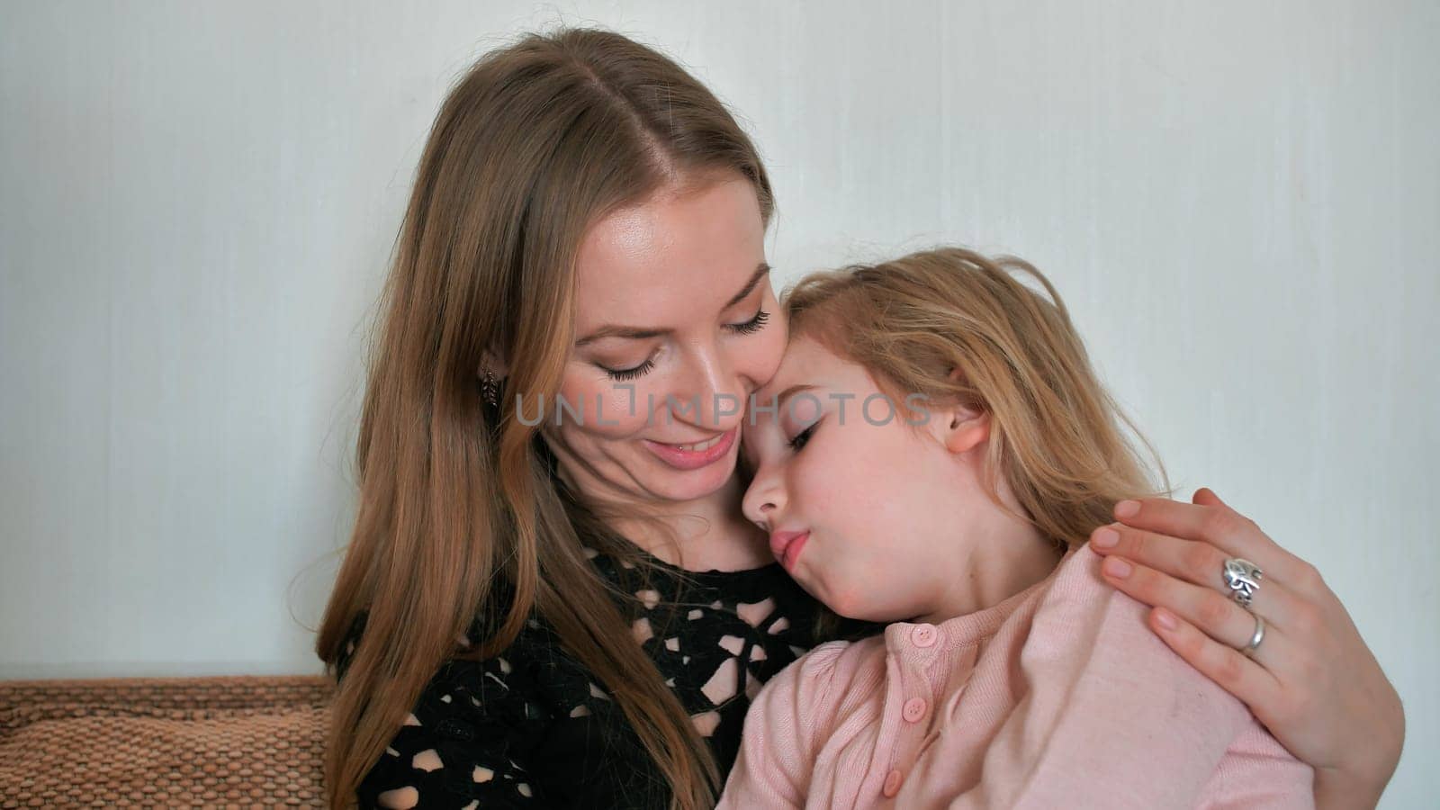 Mother calms and hugs her 6 year old daughter