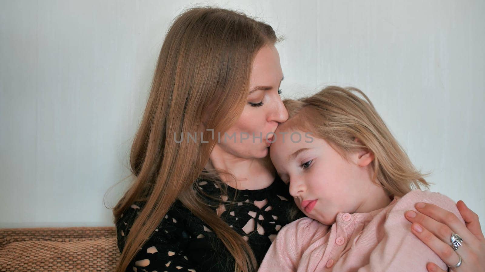 Mother calms and hugs her 6 year old daughter