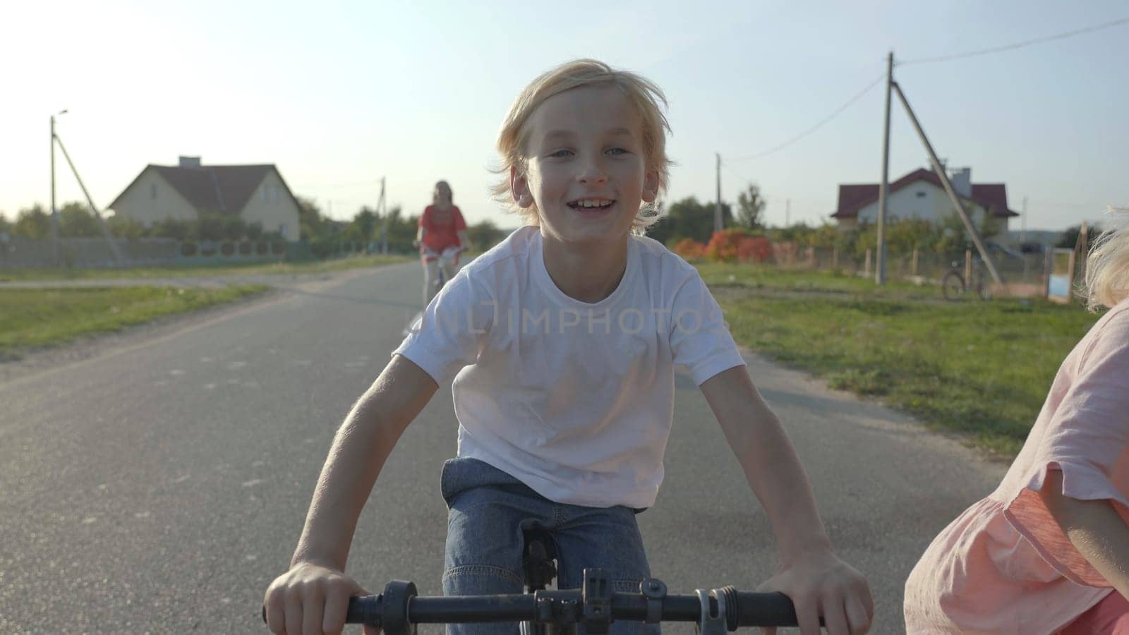 Cheerful boy on a bicycle in the village