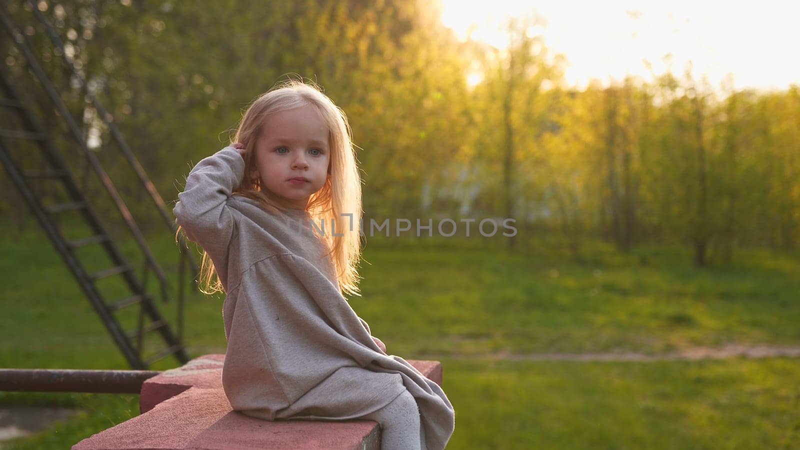 Little girl in the evening summer sunset. by DovidPro