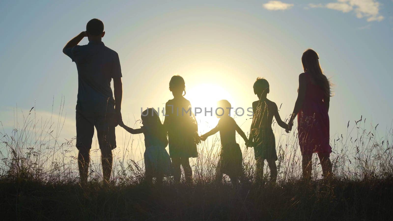 Happy large family at sunset with a dog