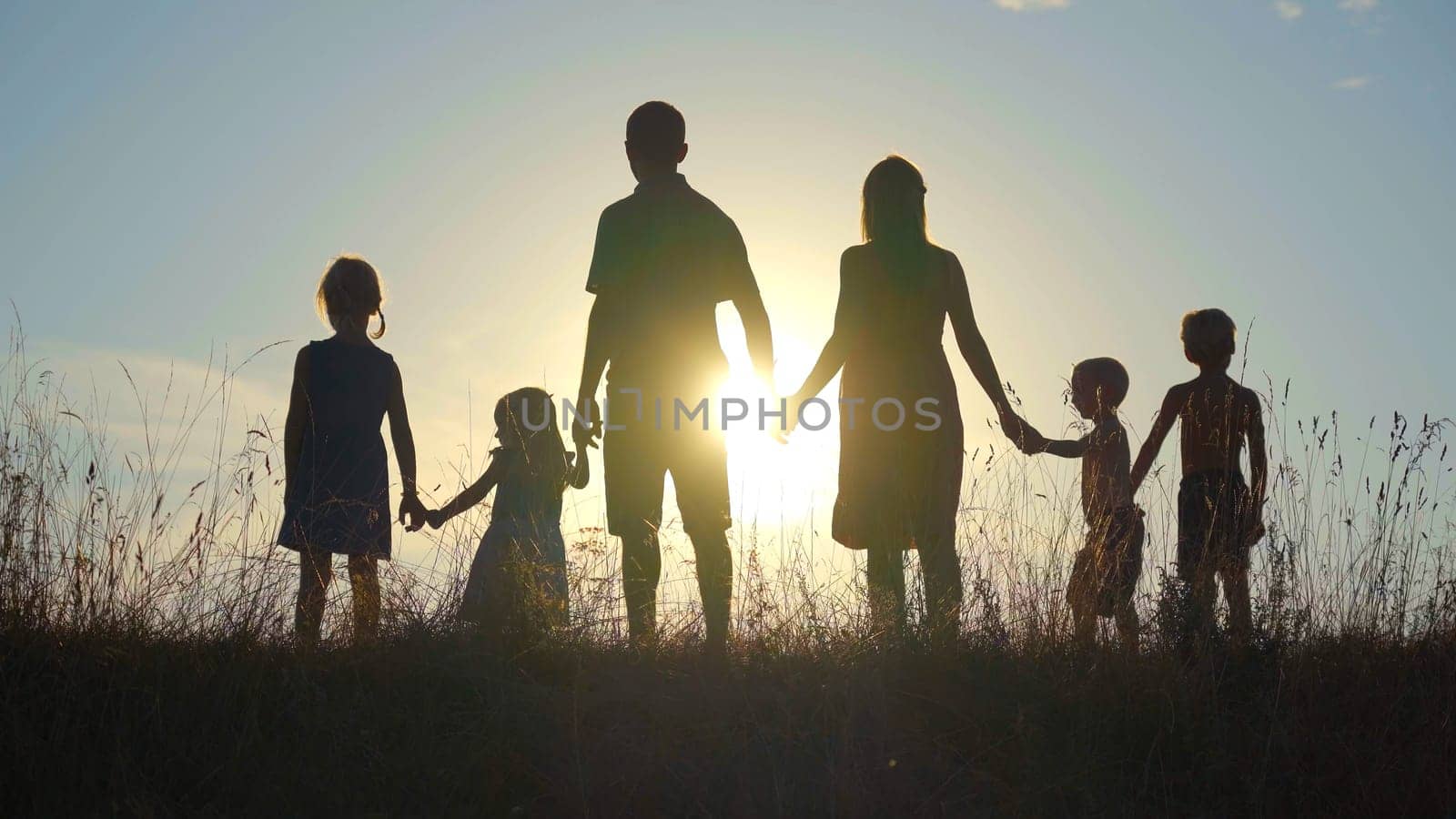 Happy large family at sunset. 6 family members