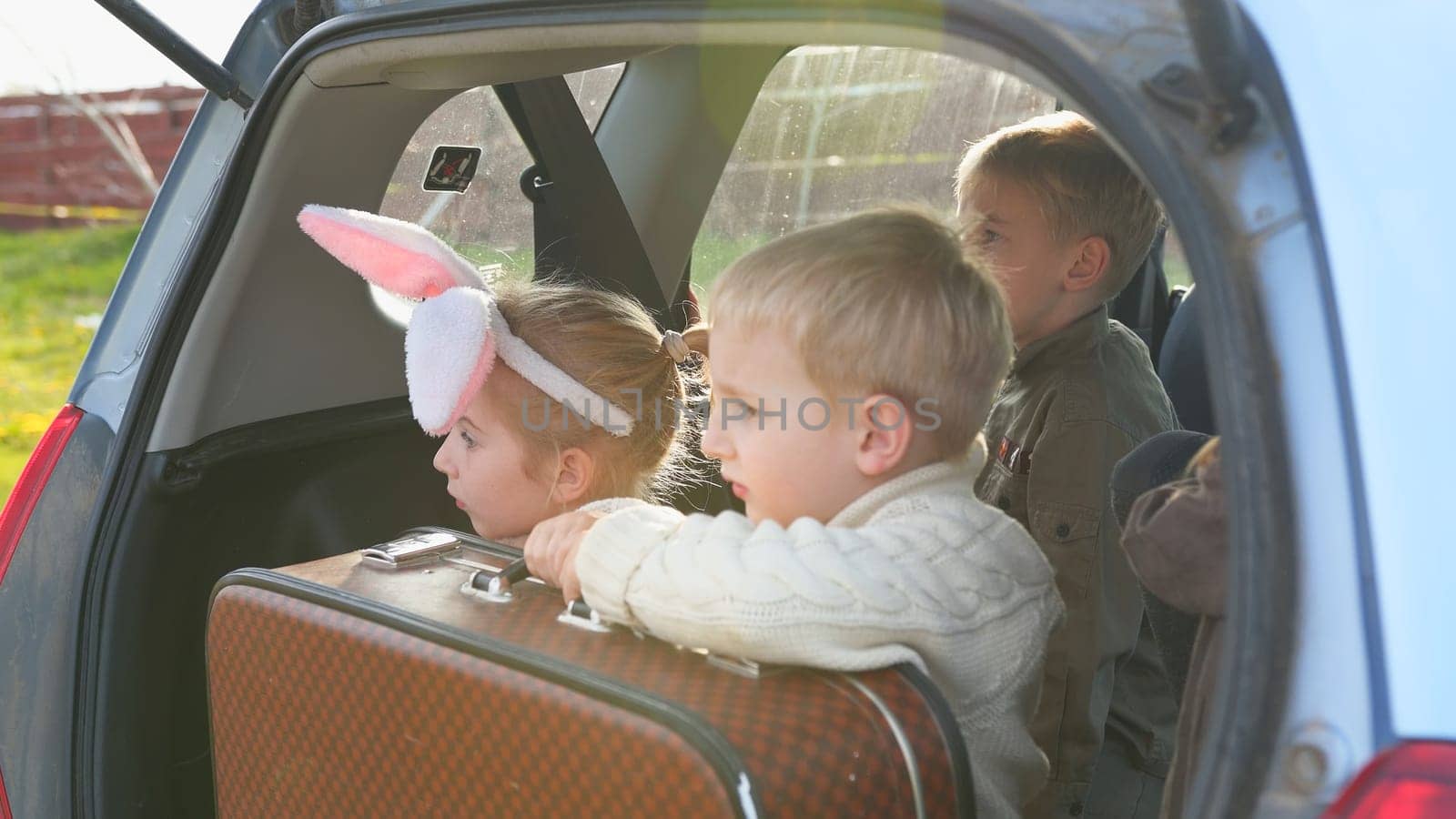 Four children in the trunk of a car before driving. by DovidPro