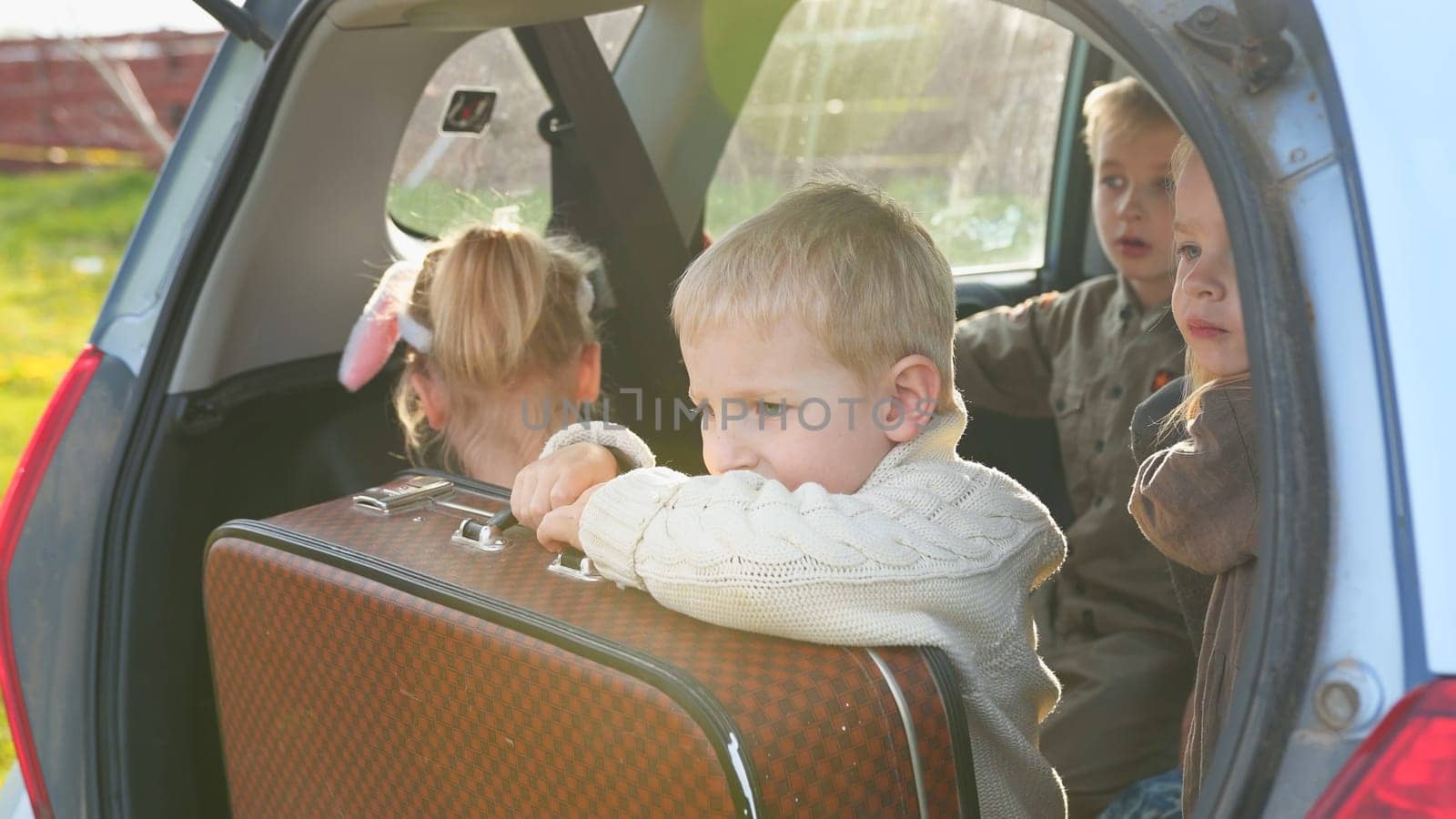 Four children in the trunk of a car before driving. by DovidPro
