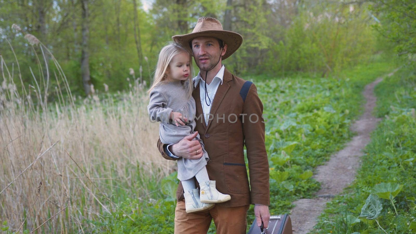 Father with a little daughter goes on a trip. by DovidPro