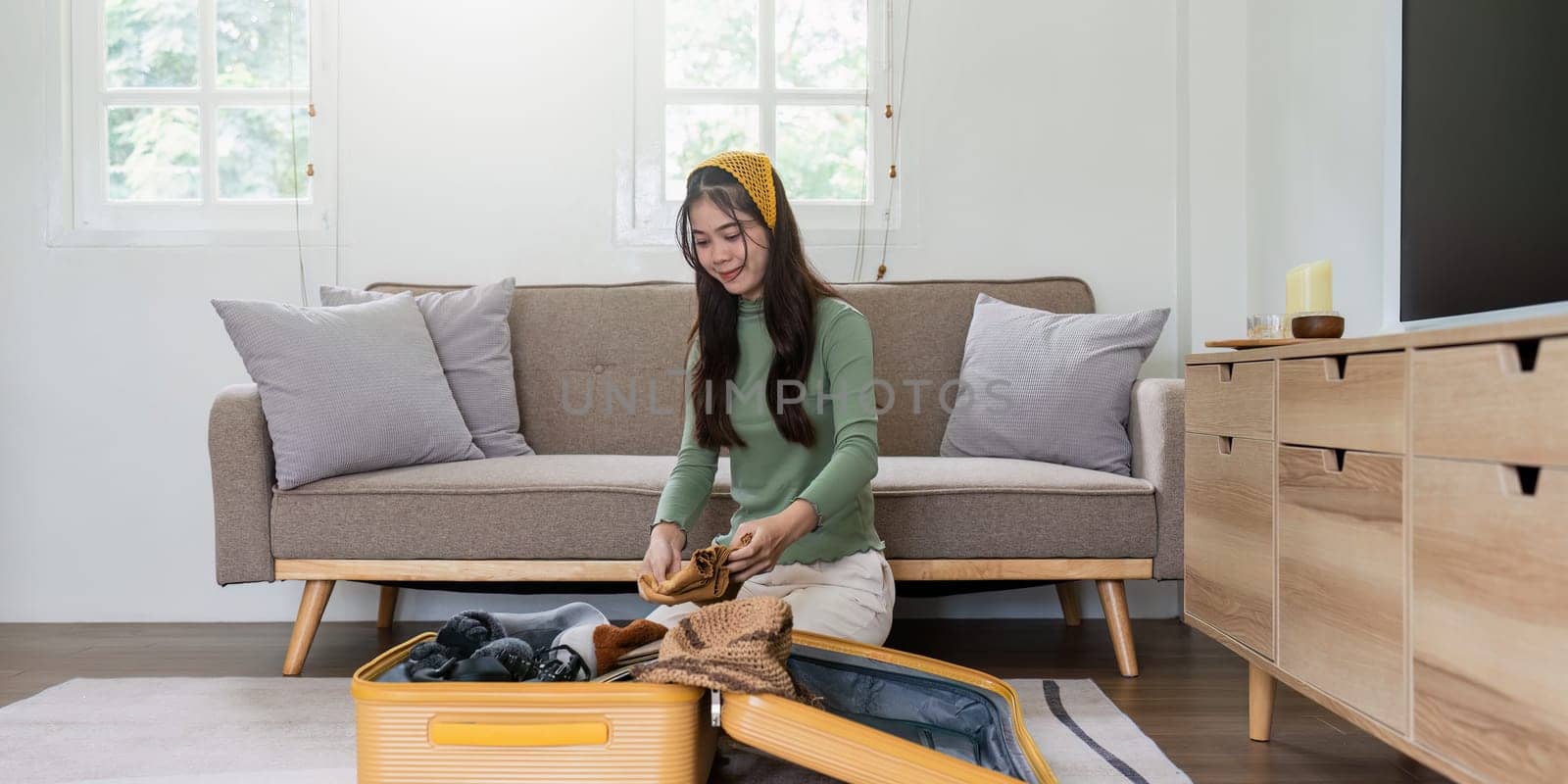 Woman packing a suitcase for a new travel trip. bag and luggage for journey.