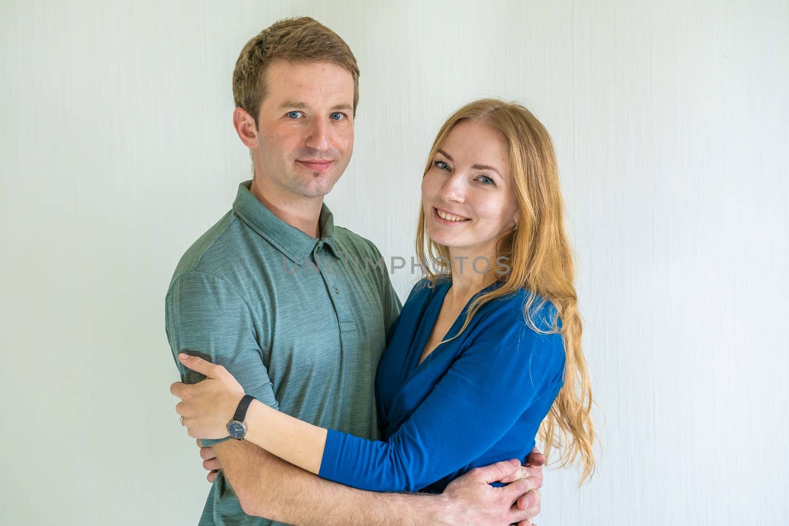 Portrait of happy young spouses at home. by DovidPro