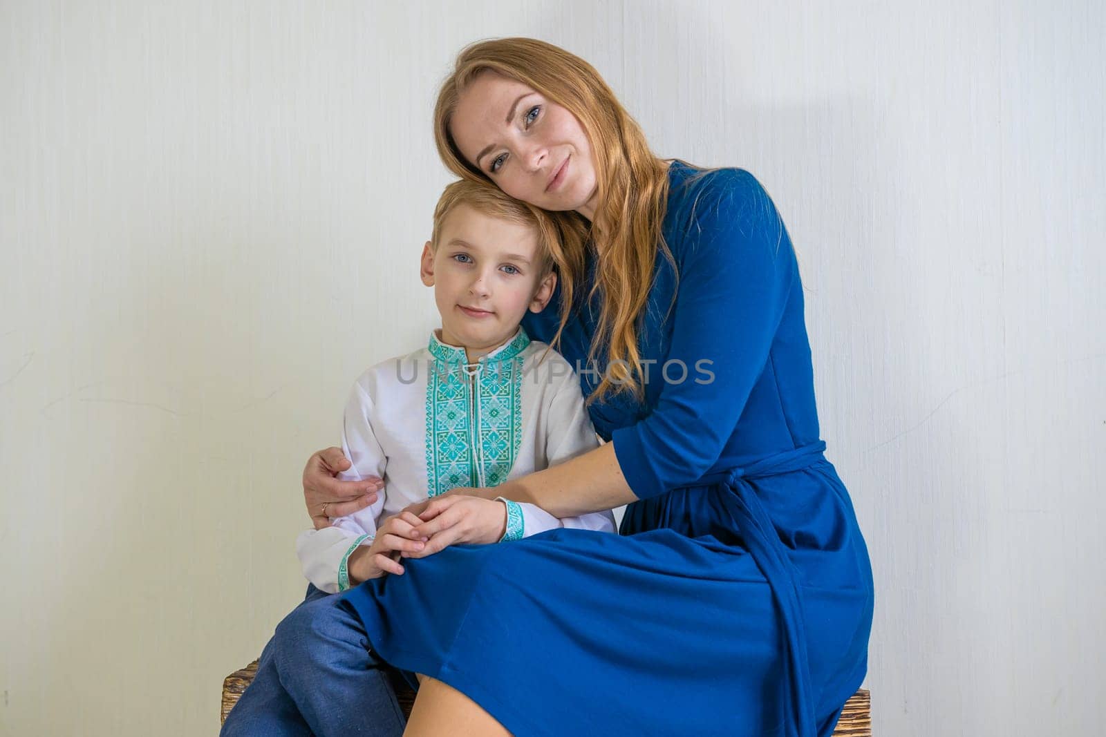 Happy young mother with her son in national Russian clothes