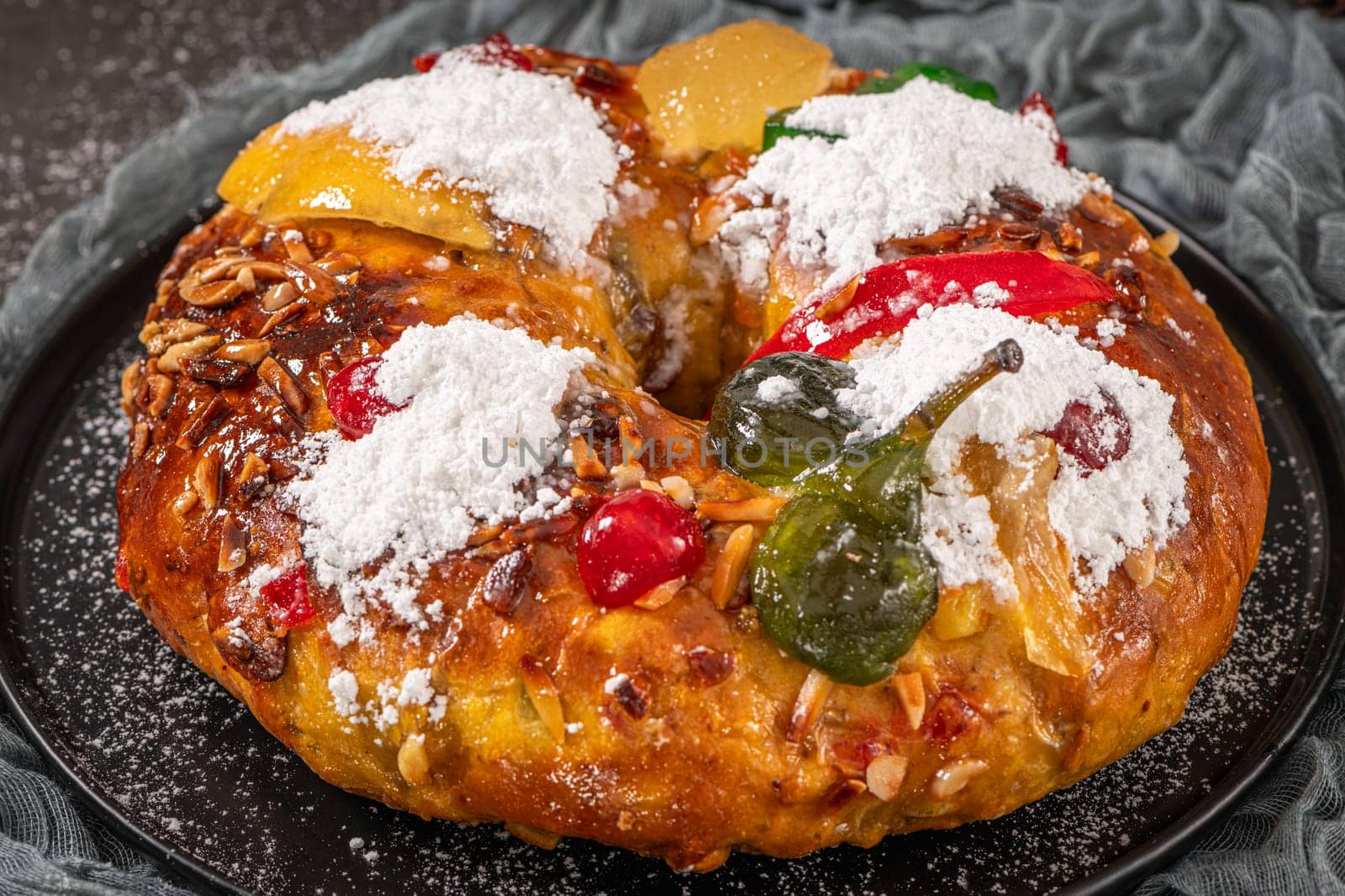 Bolo Rei or Kings Cake is a traditional Xmas cake with fruits raisins nut and icing on kitcthen countertop. Is made for Christmas, Carnavale or Mardi Gras