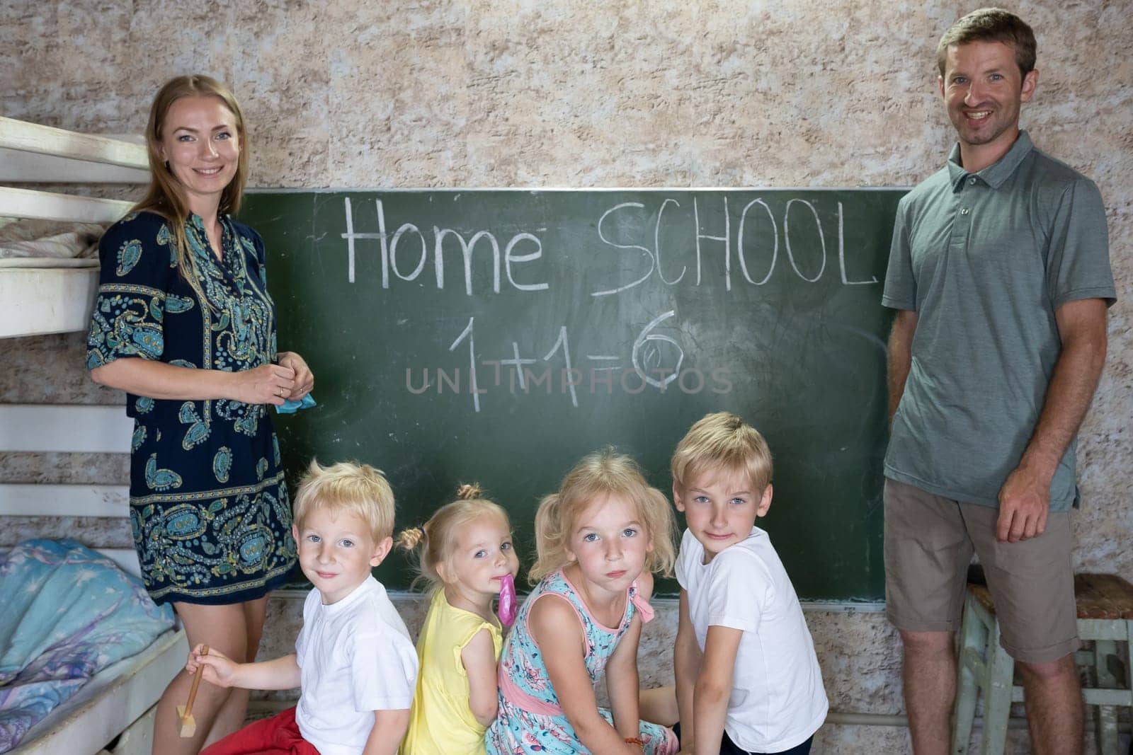 Portrait of a big family at the blackboard at home school