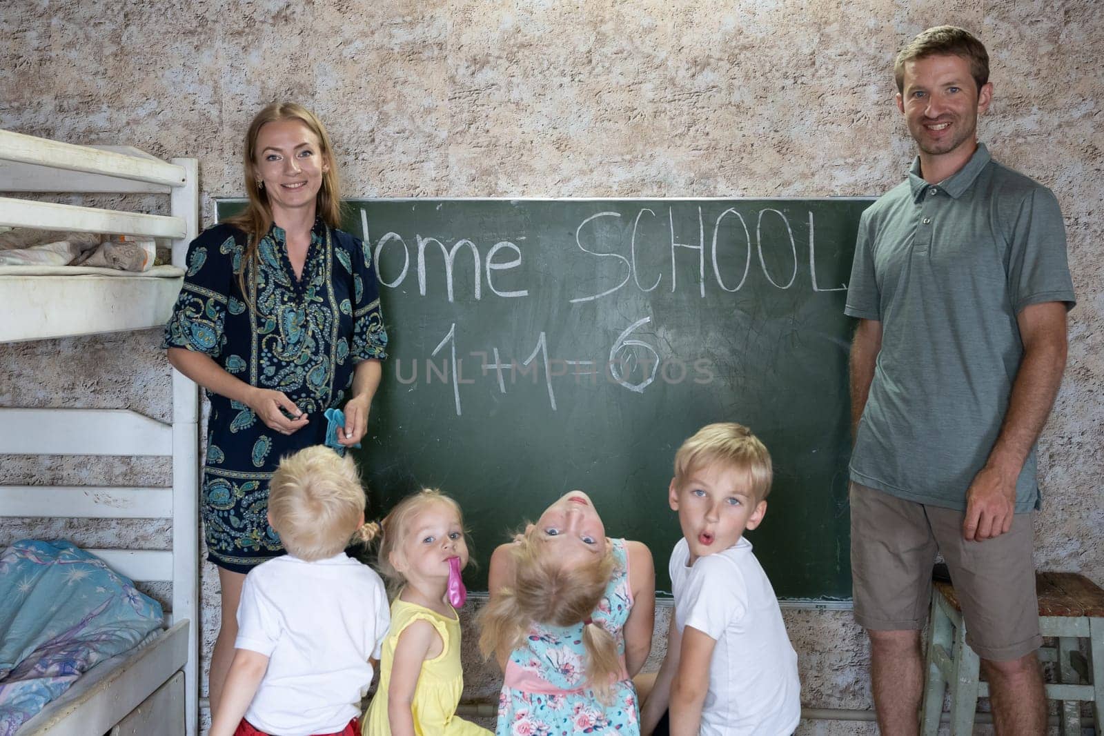Portrait of a big family at the blackboard at home school. by DovidPro
