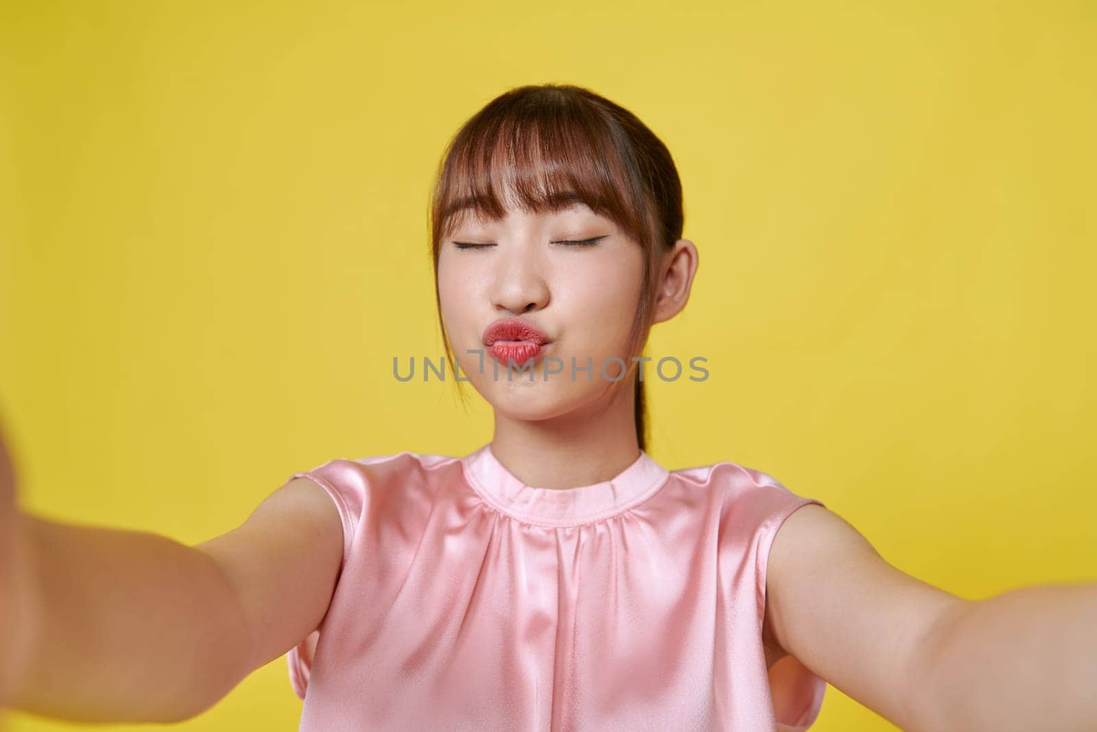 Lovable asian woman standing with kissing face expression, making selfie  by makidotvn