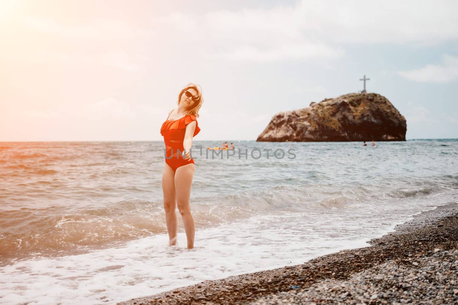 Young happy woman walks carefree on the seaside. Happy lady in red bikini. Portrait beautiful young woman relax smile around beach sea ocean in holiday vacation travel trip by panophotograph