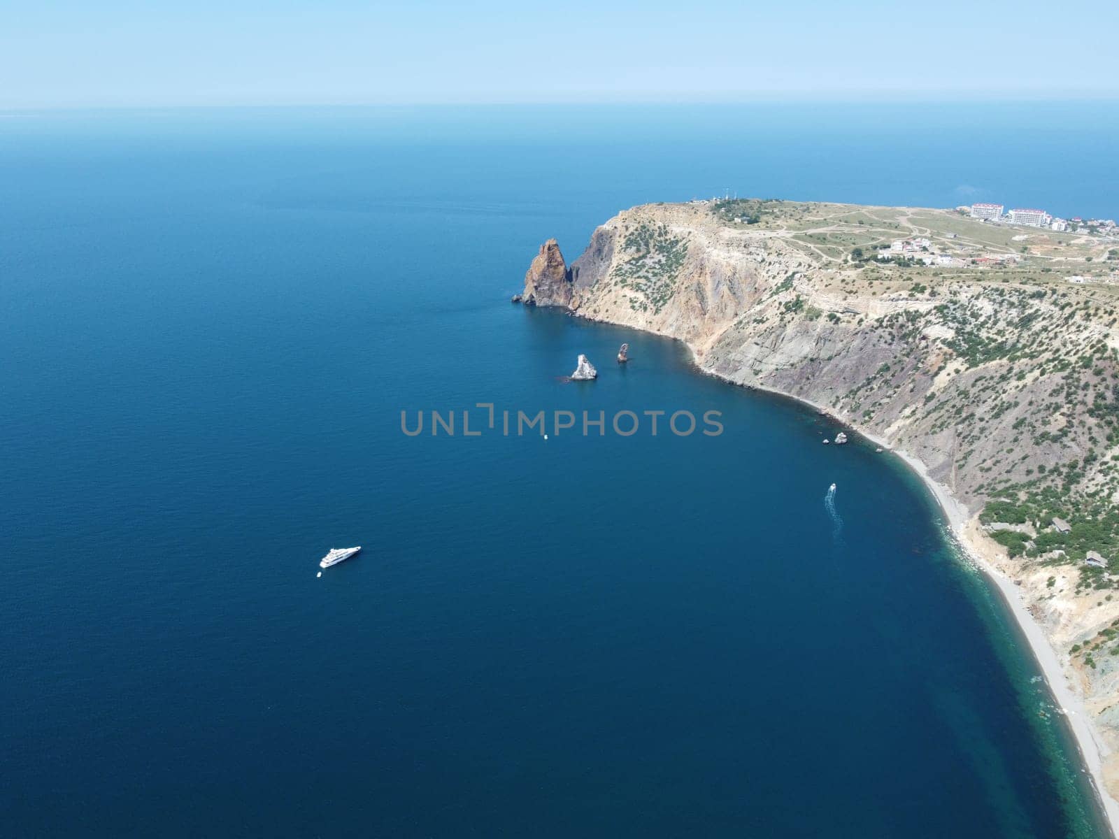 Aerial panoramic view of beautiful sunset above sea. Beautiful seascape. Sun glare, small waves on the water surface. Evening. Horizon. Nobody. No people. Copy space. Never-ending beauty of nature