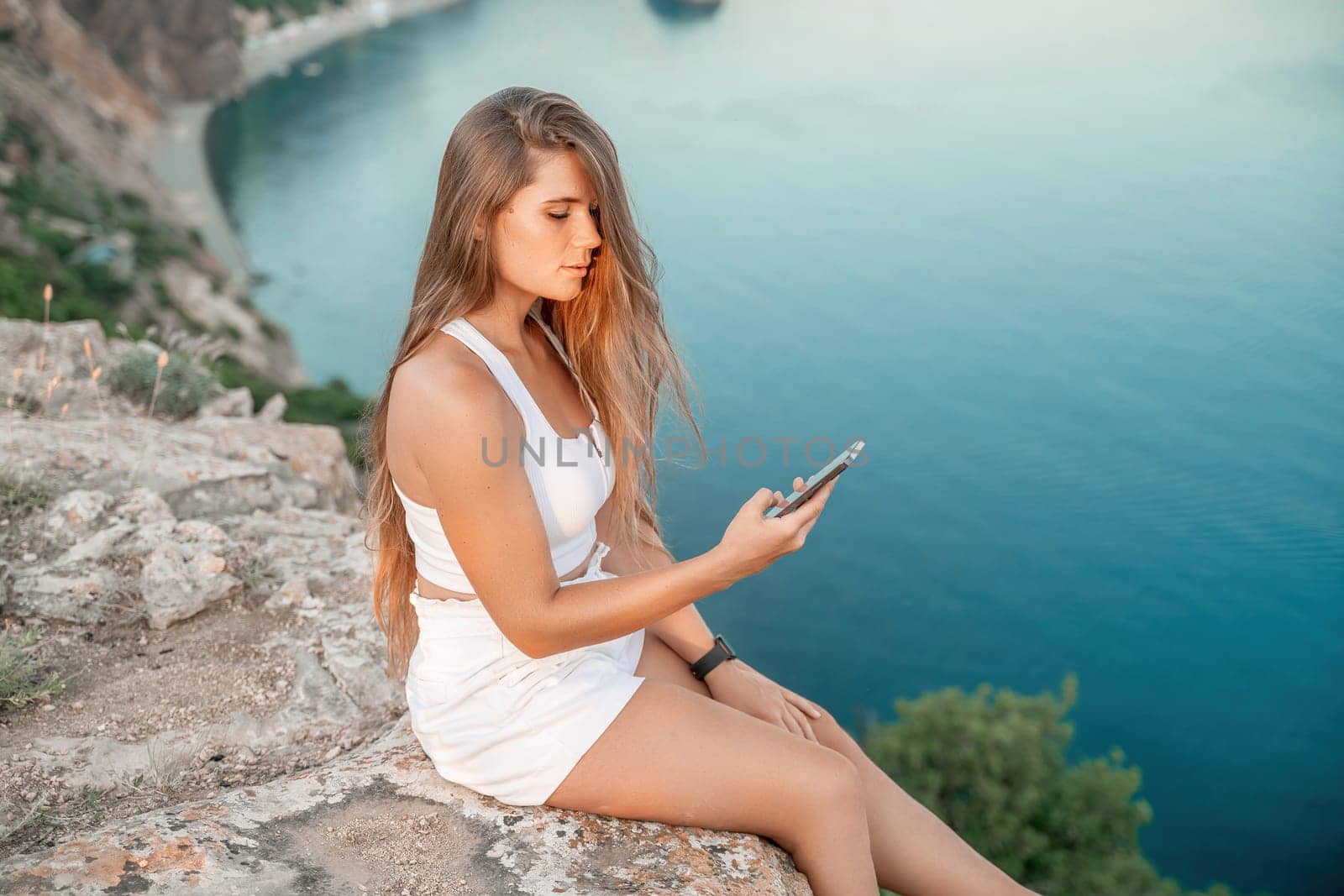 Portrait of a happy woman with long hair against the sea.