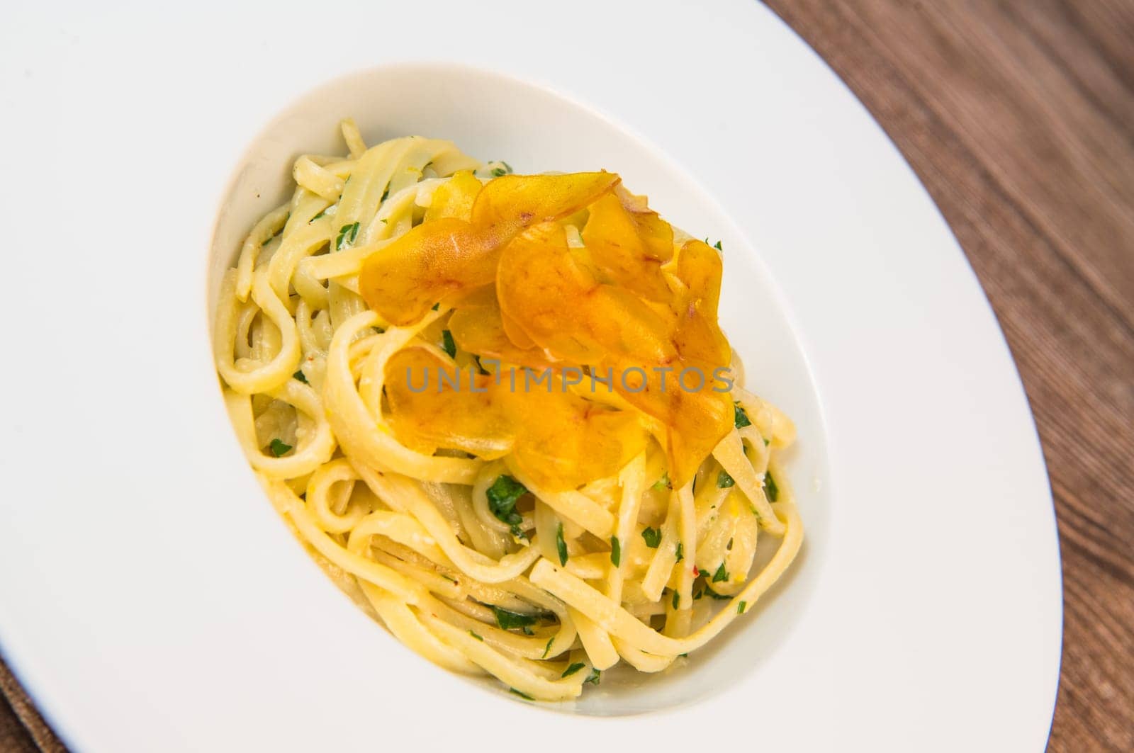 LINGUINE PASTA RECIPE WITH POUTARGUE, LEMON, GARLIC, LEMON ZEST, FRESH CREAM AND PARSLEY. High quality photo