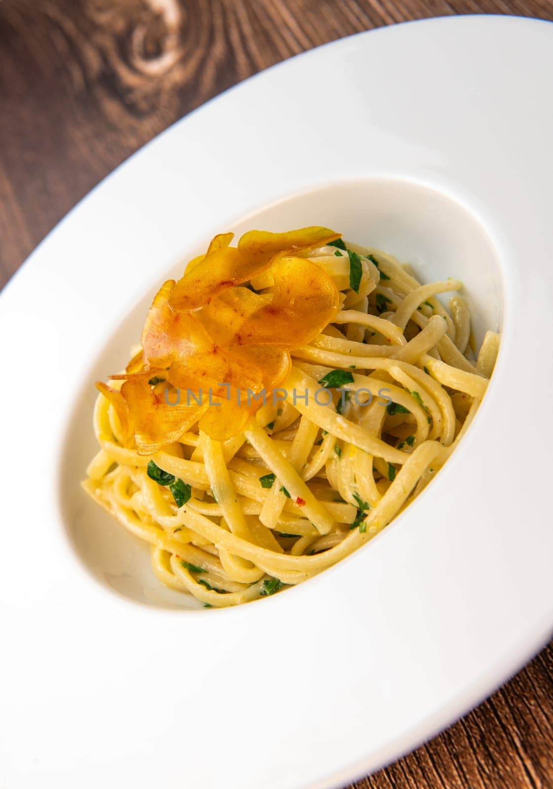 LINGUINE PASTA RECIPE WITH POUTARGUE, LEMON, GARLIC, LEMON ZEST, FRESH CREAM AND PARSLEY. High quality photo