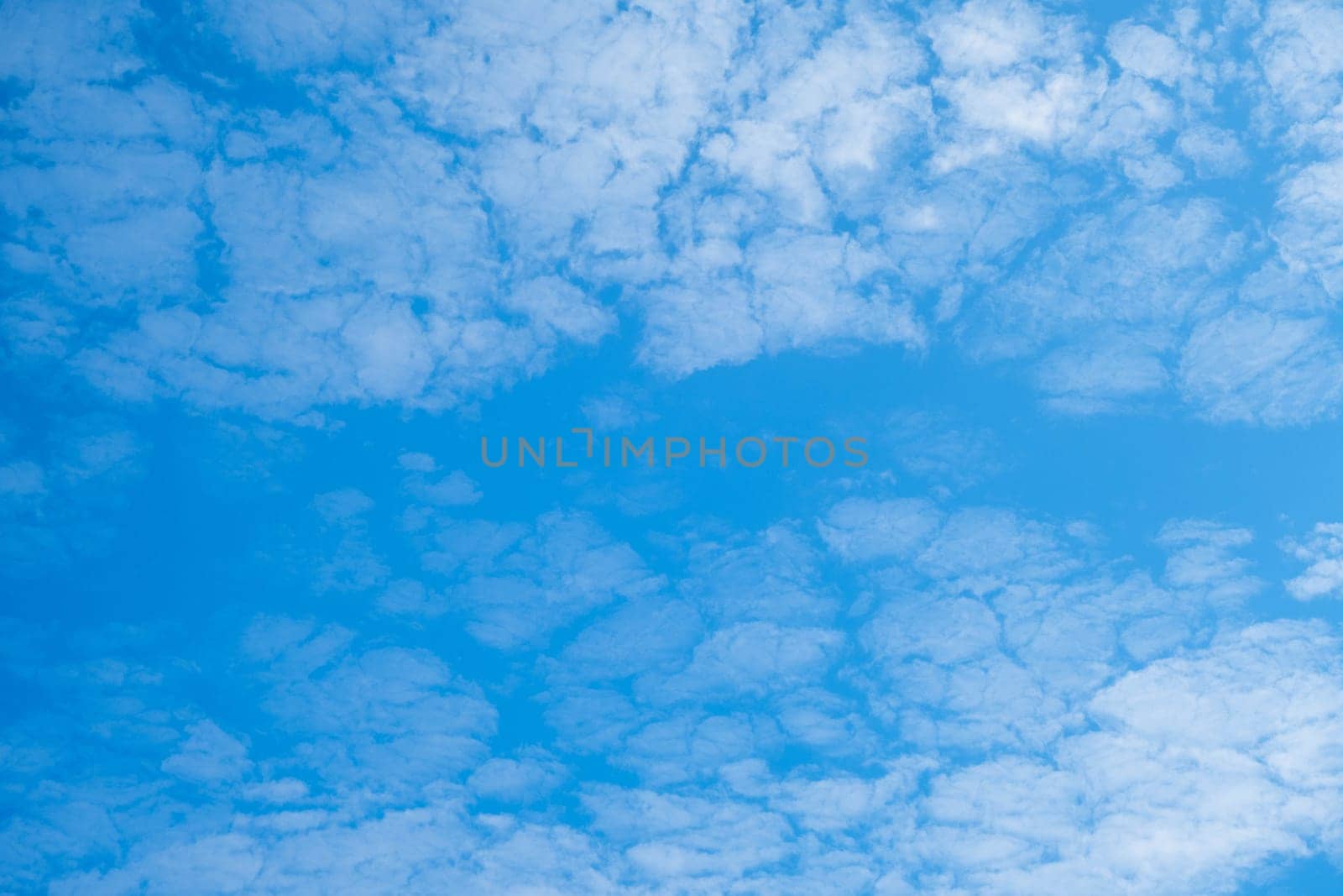 Beautiful sky with clouds and sun on a summer day. Time lapse of clouds above the blue sky with the sun shining. Sky nature background.